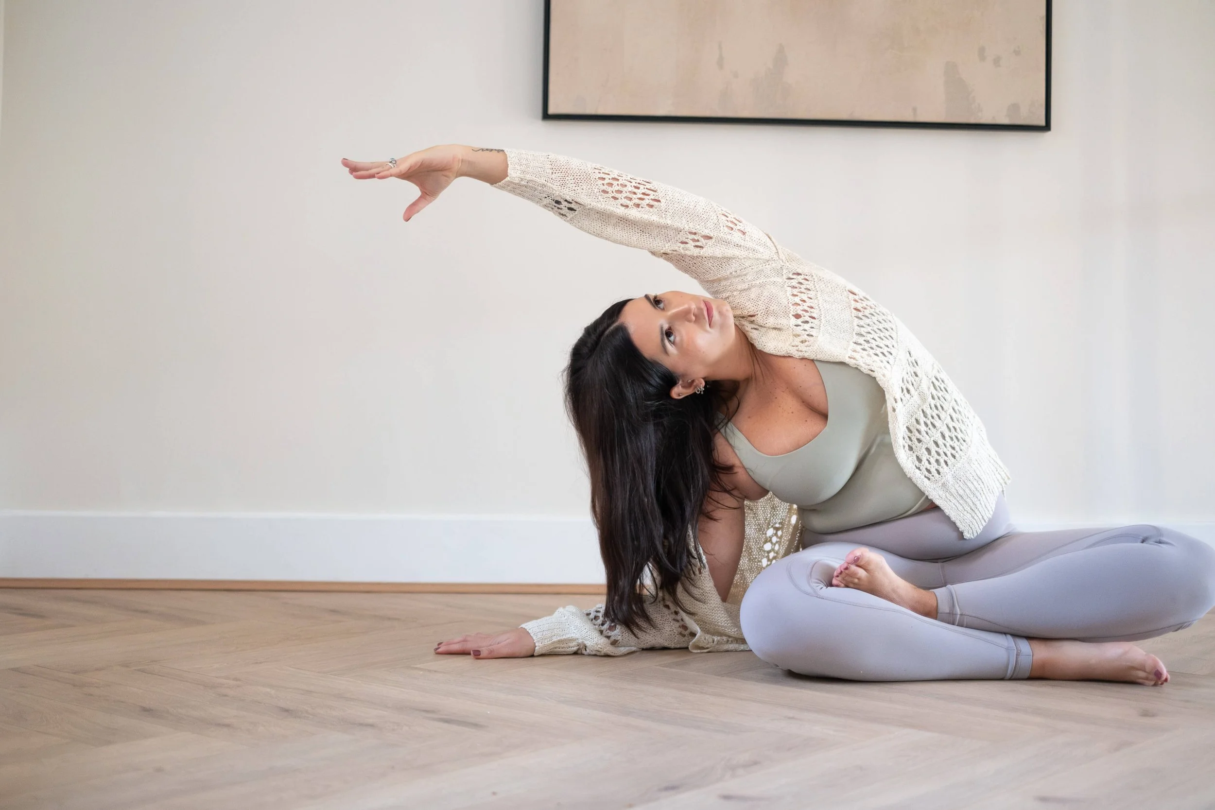 Ari Yoga Healing performing seated side stretch