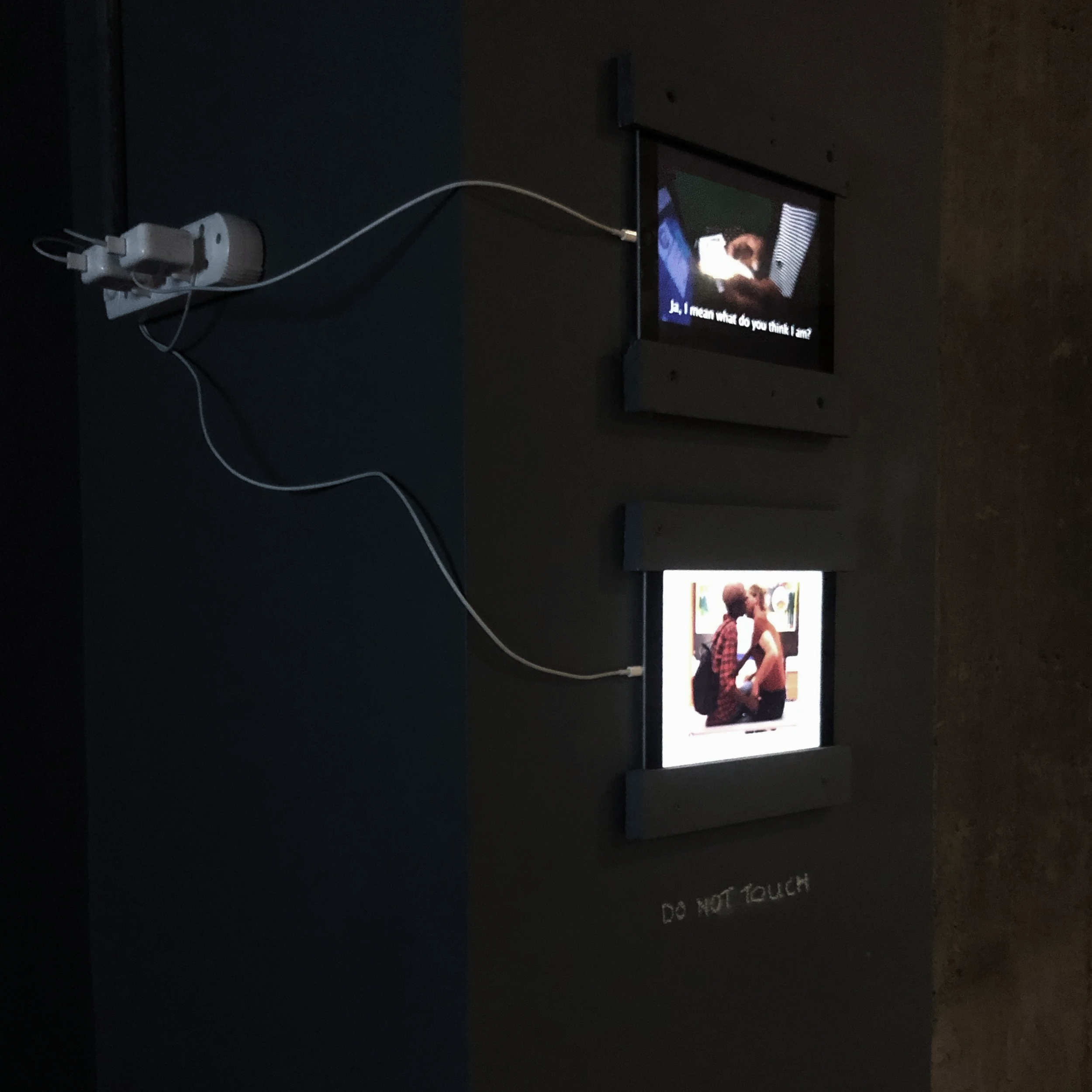 The Centre for the Moving image at Zeitz Museum Contemporary Art Africa. Brett Seiler, Russell Bruns, performance documentation screens. Two men kissing.