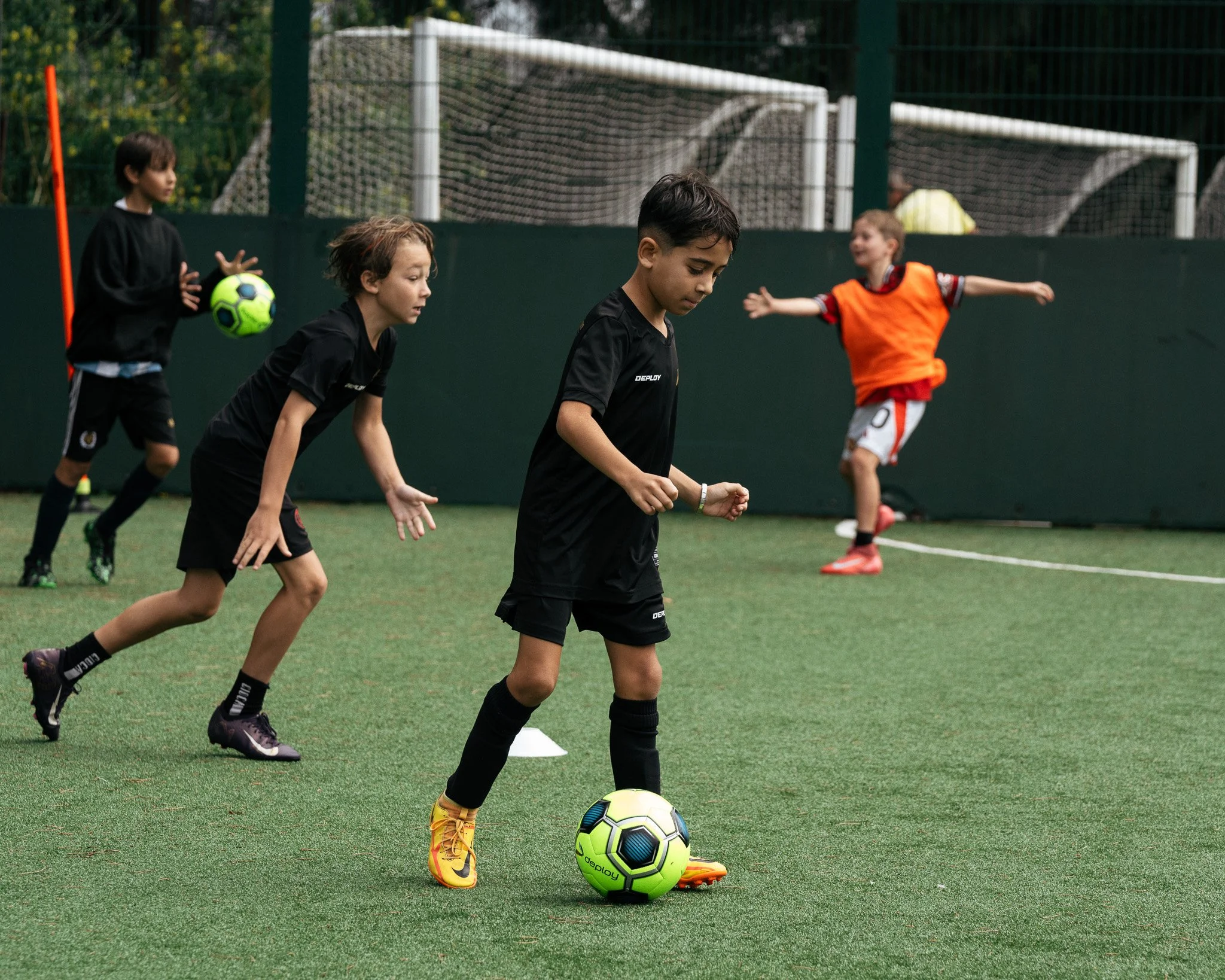 Young football players taking part in a small-group training exercise at KB Football Academy.