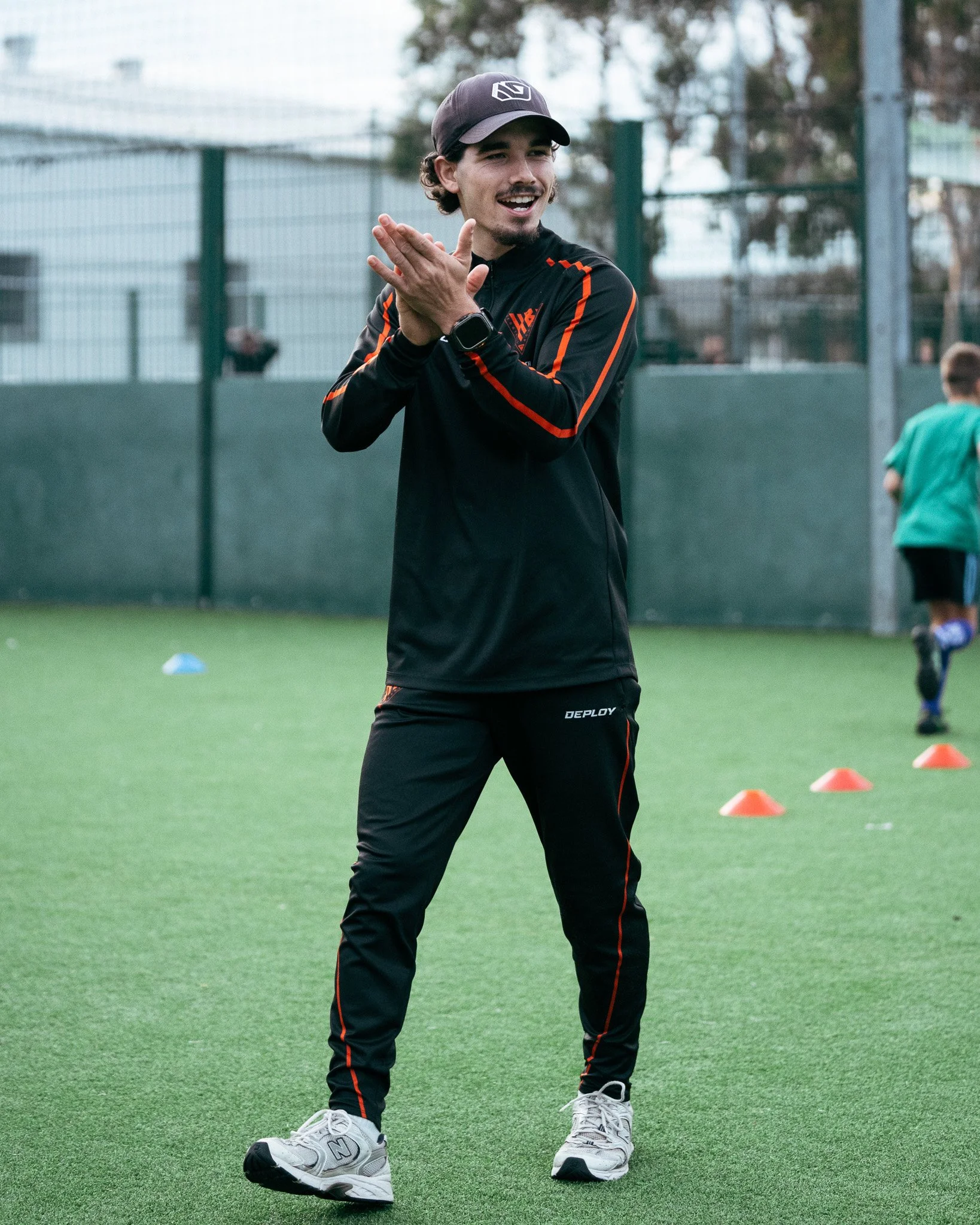 KB Football Academy coach encouraging players during a football training session.