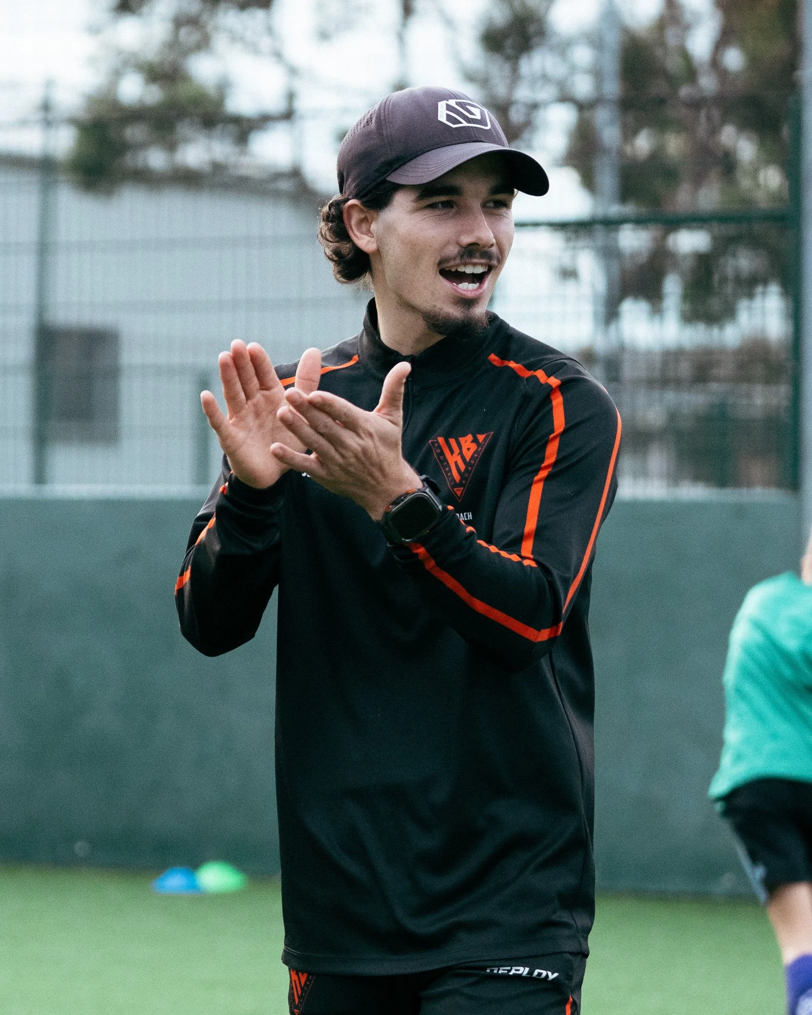 KB Football Academy coach encouraging players during a junior football training session.