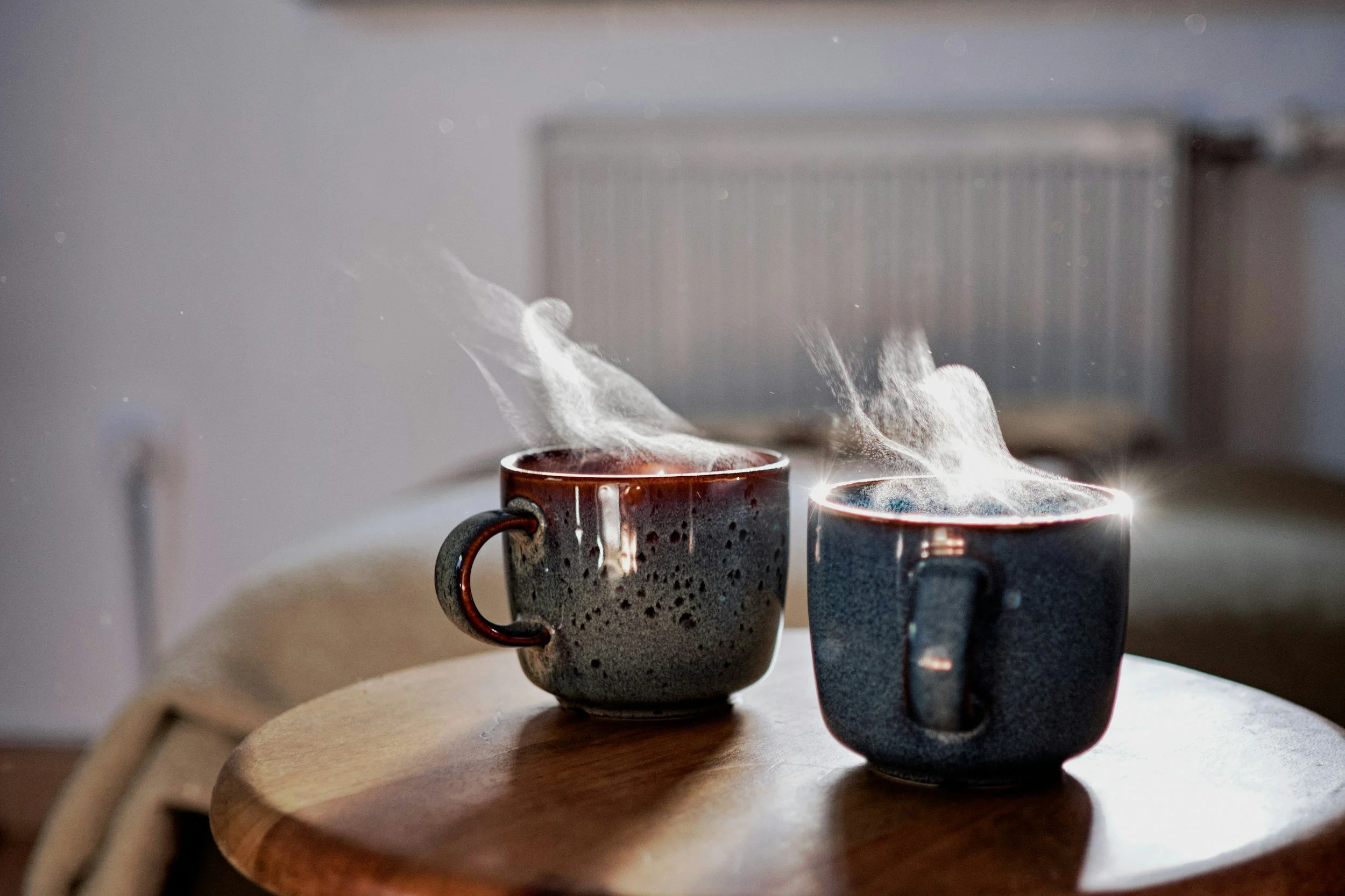 Two ceramic mugs on a table representing a conversation and supportive space