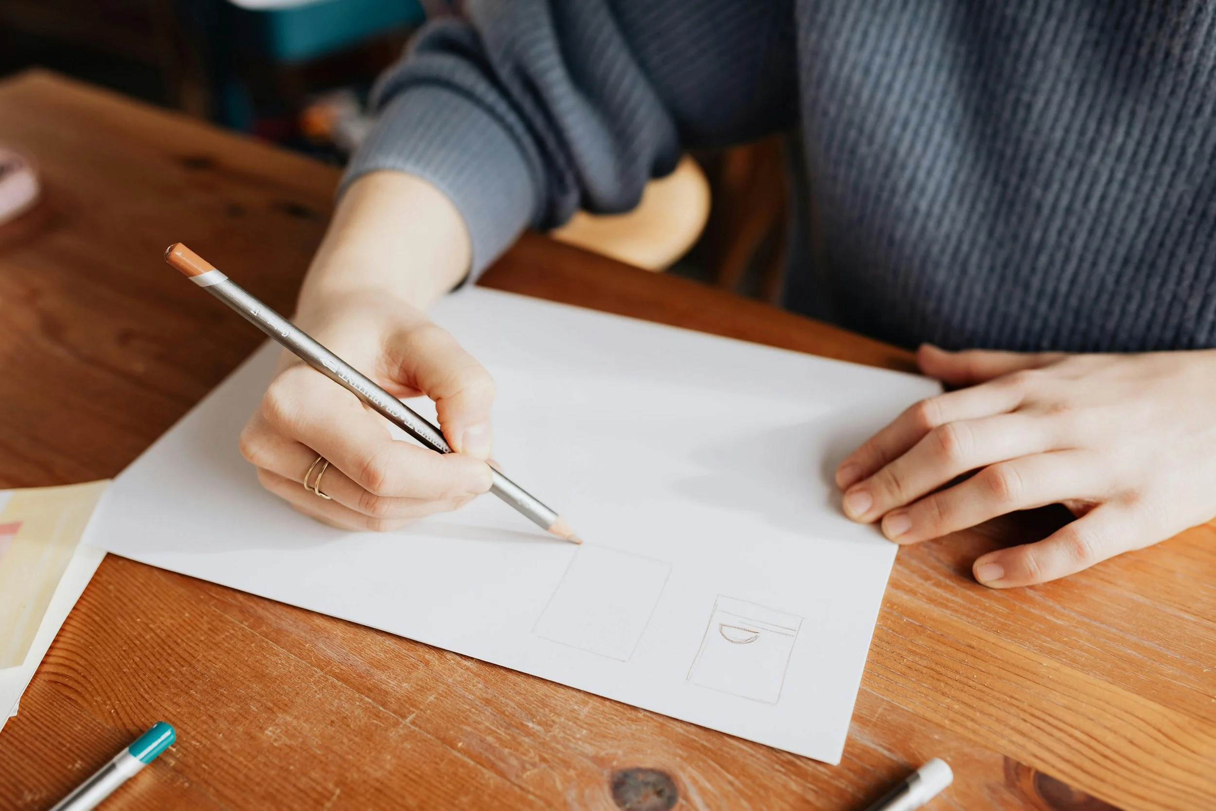 Graphic Designer sketching logo at desk