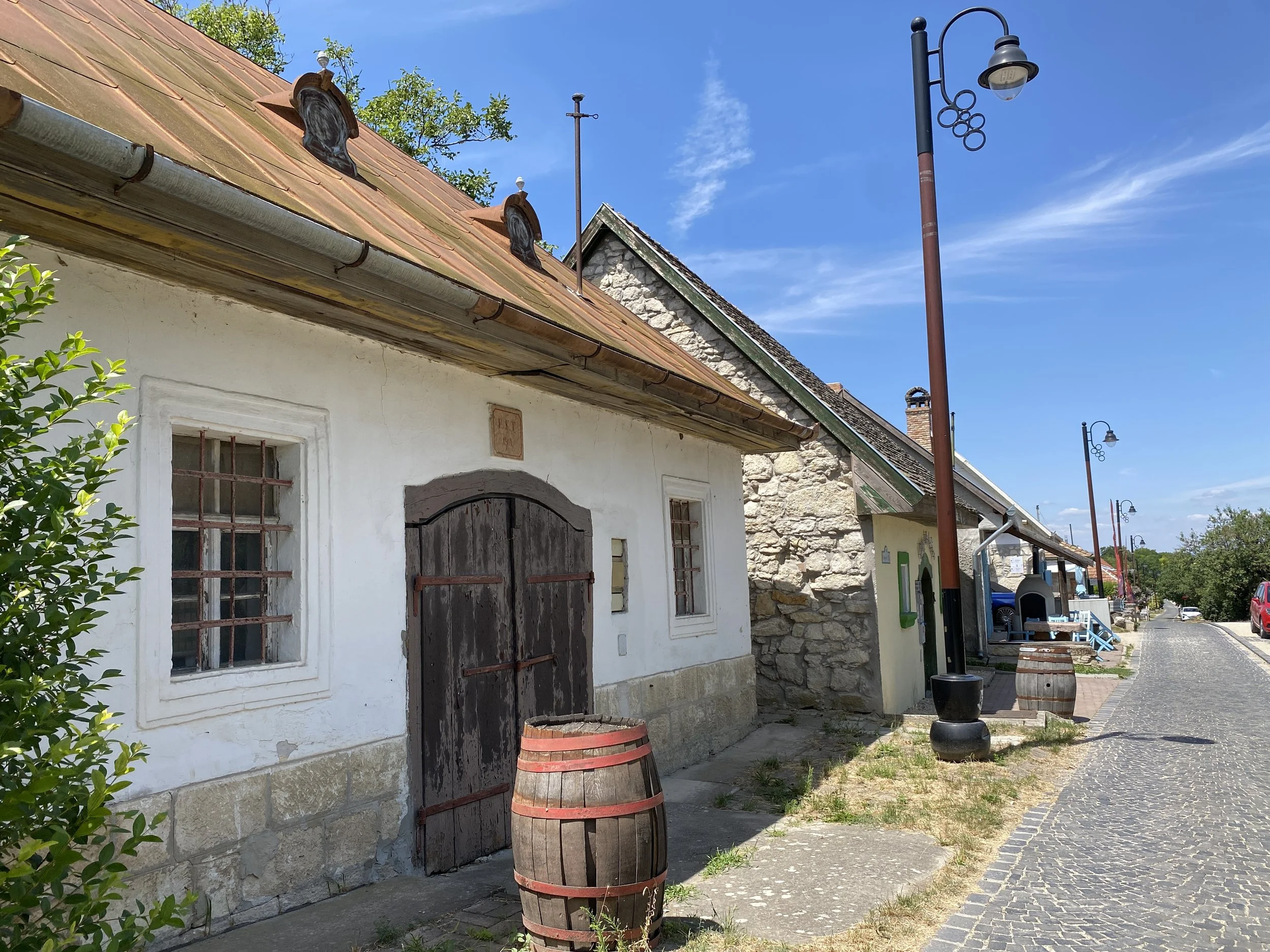 Traditional houses with wine barrels on village street  in Etyek, Hungary