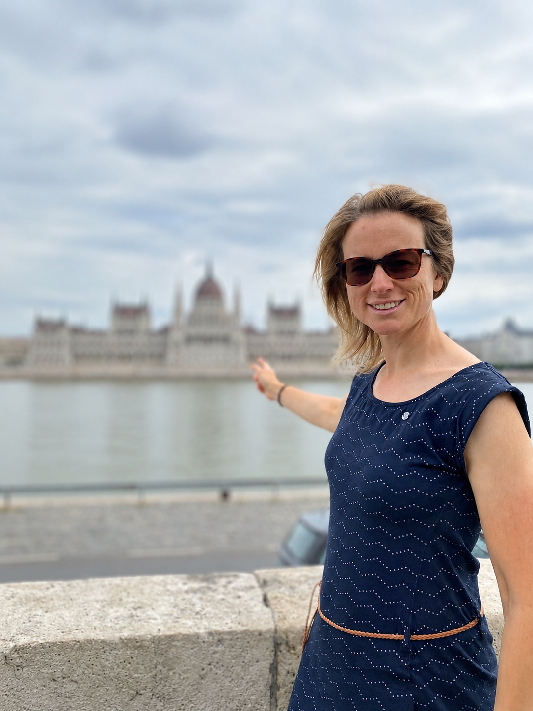 Tour guide pointing at Parliament building in Budapest, Hungary