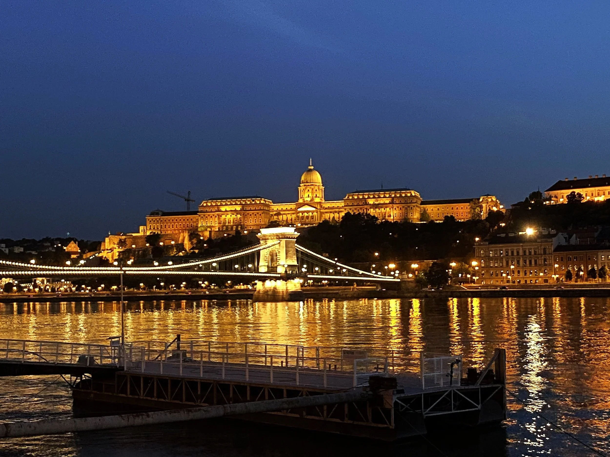 Night view of the lit up Chain Bridge and the Royal Palace from the Danube in Budapest, Hungary