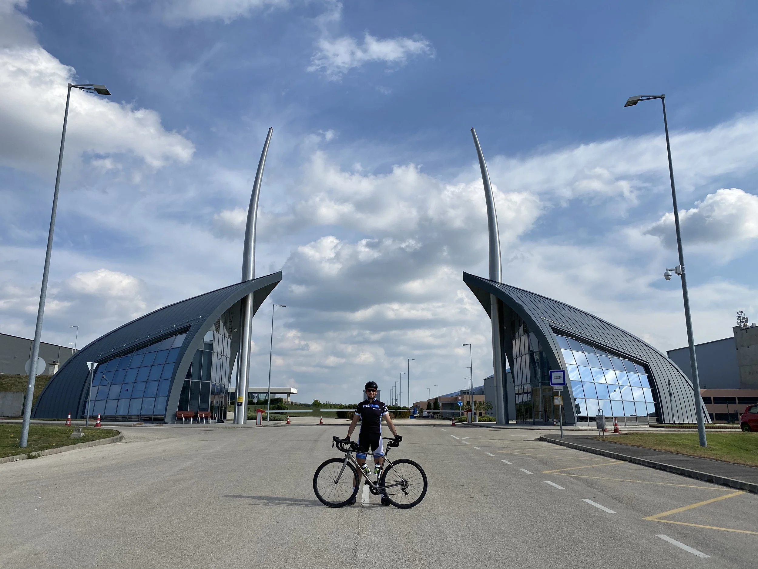 Cyclist posing in front of Korda Film Studios in Etyek, Hungary