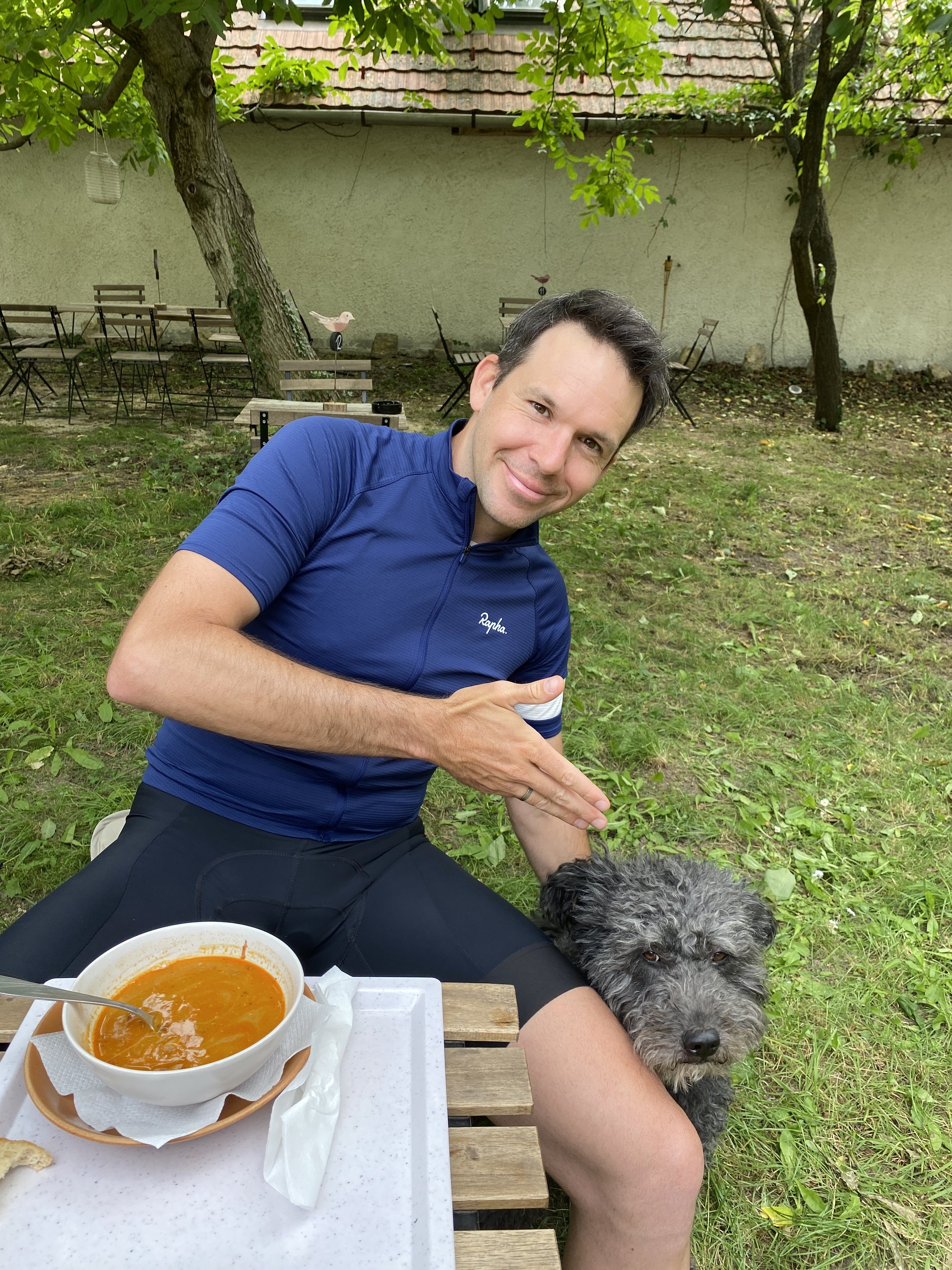 Happy cyclist with gulash soup and puli