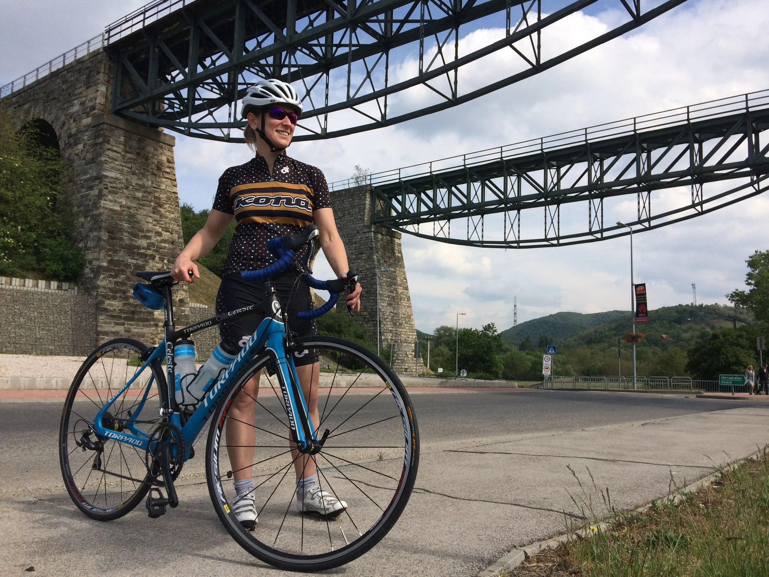 Cyclist posing in front of historical viaduct in Biatorbágy