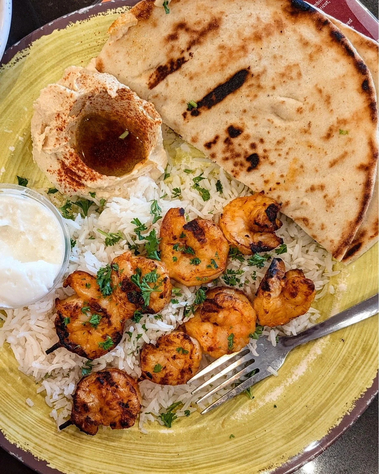 Perfect for Taco Tuesday and all other days! Our flame grilled harissa shrimp dishes include a Shrimp Taco, a Bowl (not featured) and a Platter. Seasoned with harissa - a fiery and aromatic North African chili paste, all three options are available a