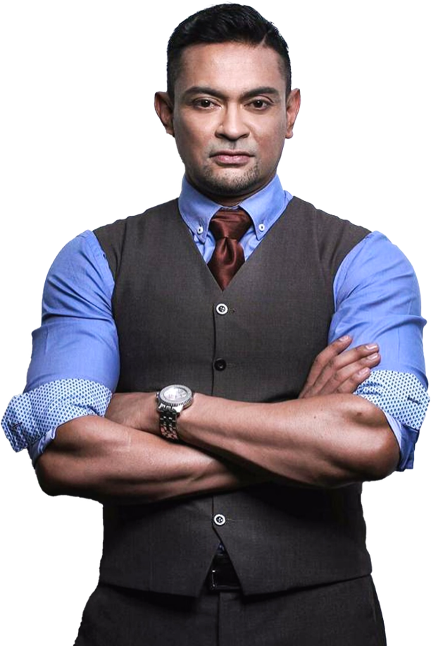 Man with crossed arms wearing a blue shirt, dark vest, and a tie.