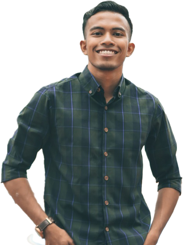 A young man smiling, wearing a dark green and blue plaid button-up shirt with his hands on his hips.