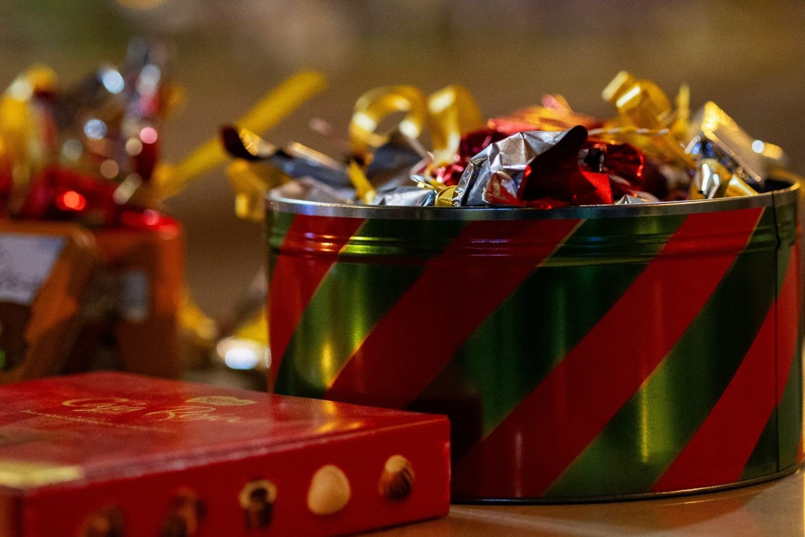 Red and green striped tin full of Christmas chocolates