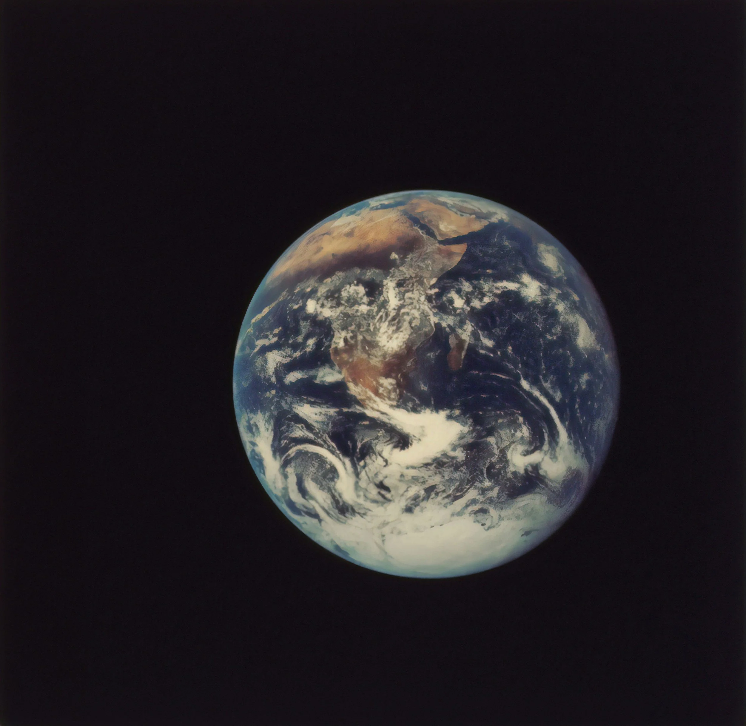 Earth as seen from space with a dark background of outer space.