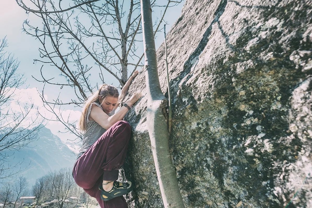 young-female-boulderer-climbing-boulder-lombardy-2025-04-03-03-56-17-utc.jpeg