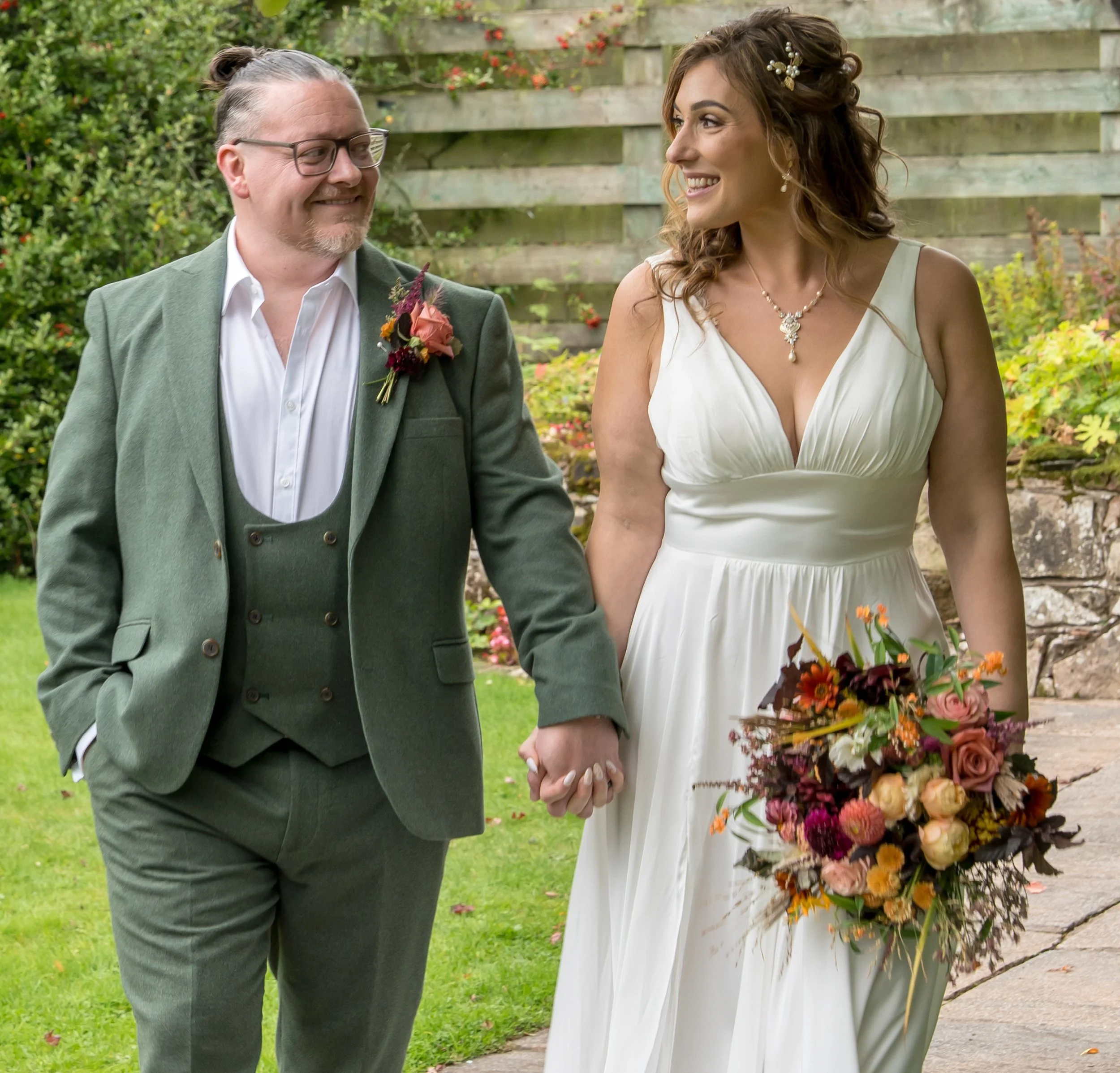 A Groom and his bride, who is holding her bridal bouquet.