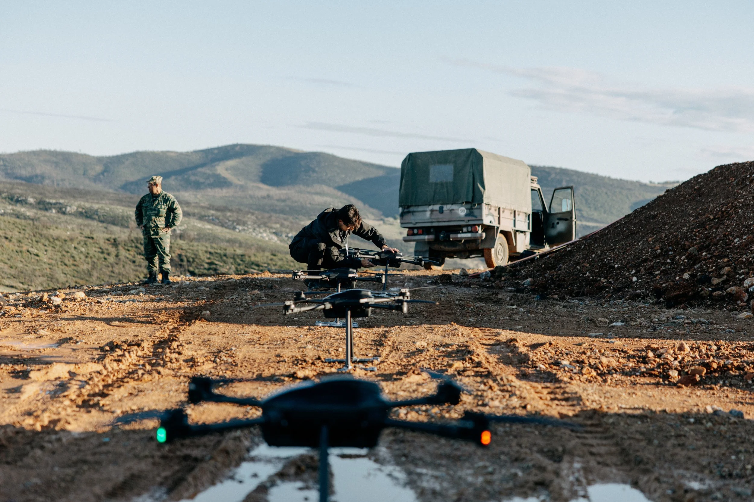 Delian engineer making adjustments to a drone during a counter-UAV exercise.