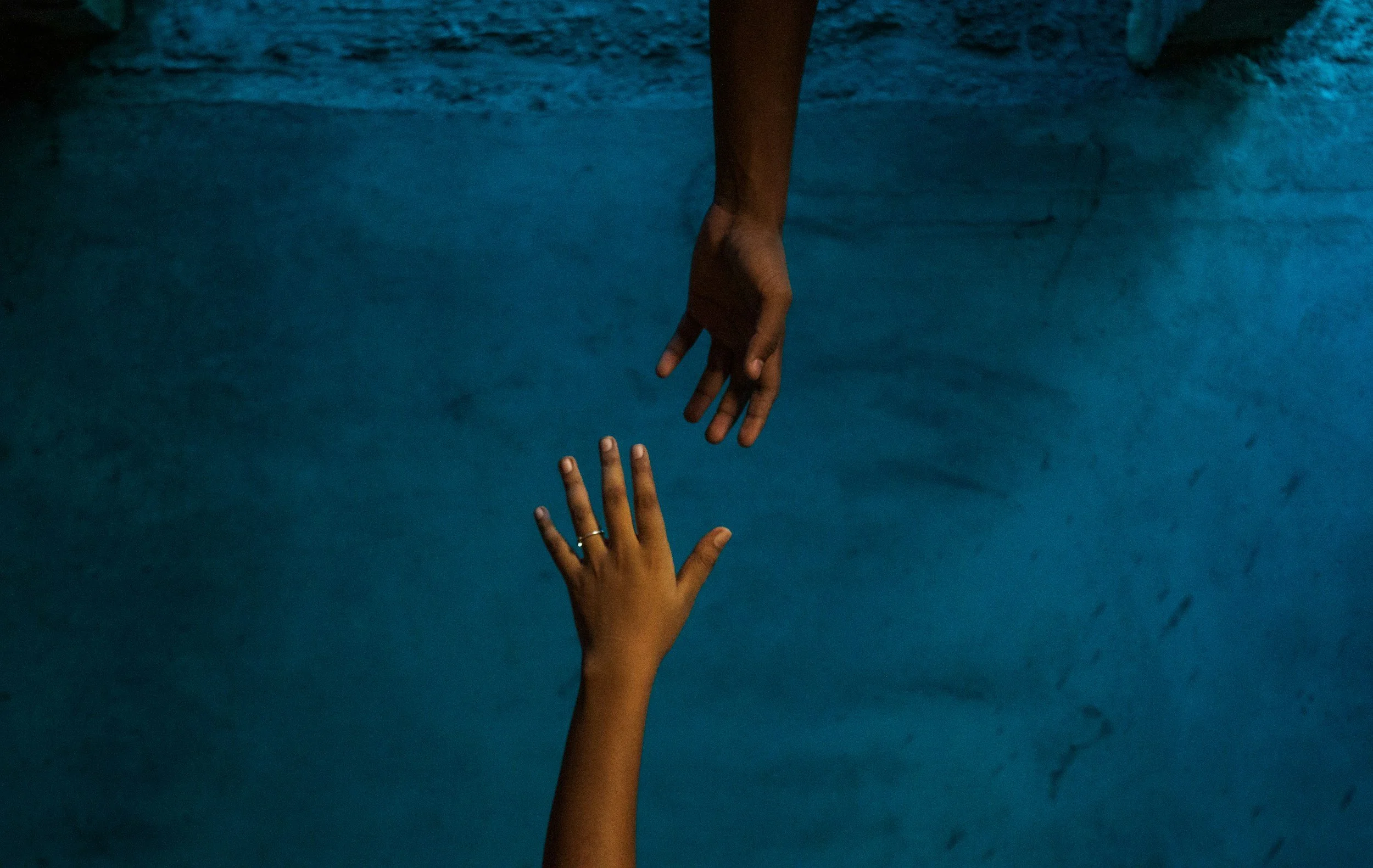 Two hands reaching toward each other, symbolizing support after an adult ADHD, autism, or AuDHD diagnosis
