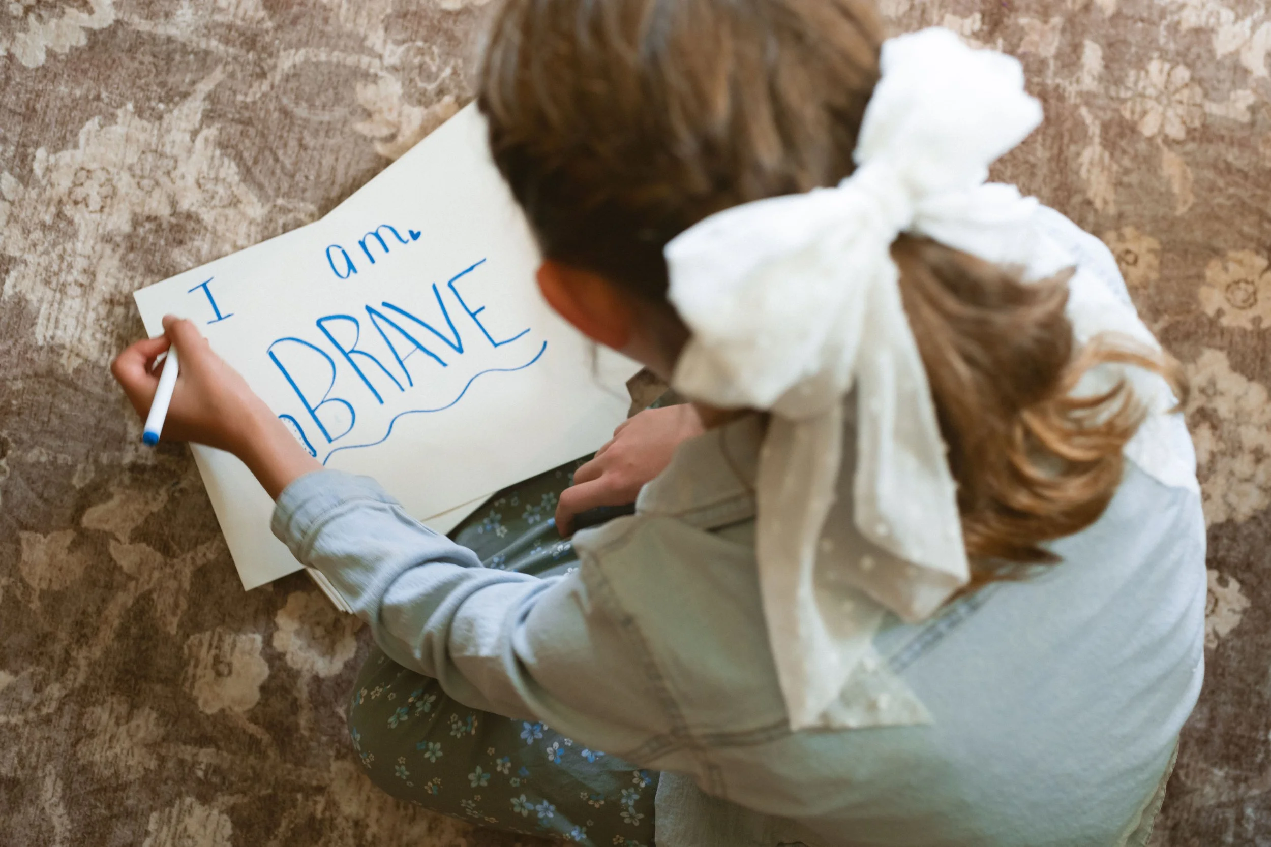 Therapist taking notes in a spiral notebook during a counseling session at The Haven