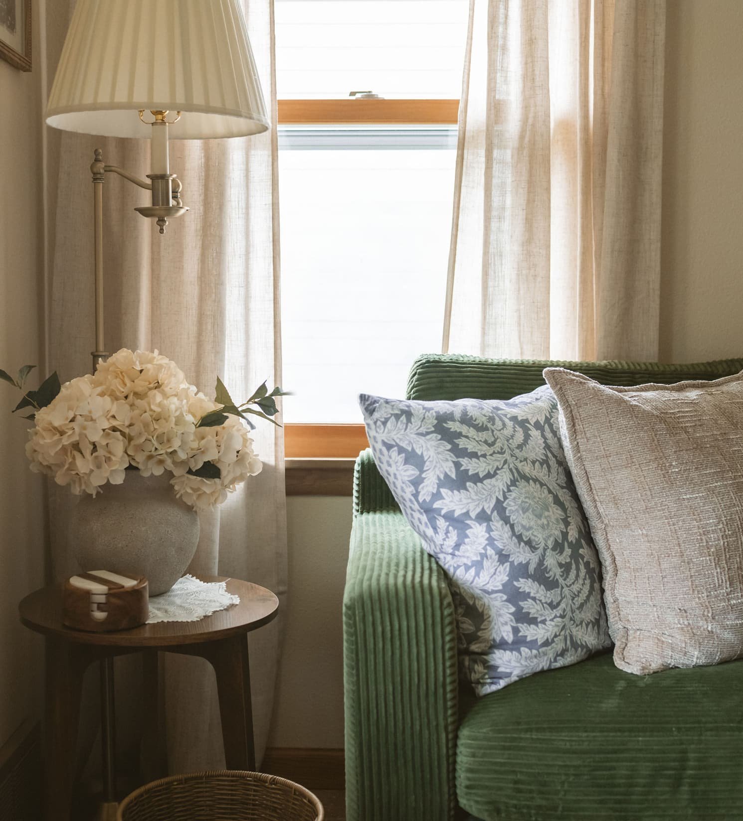Cozy green couch with patterned pillows in a therapy office corner at The Haven