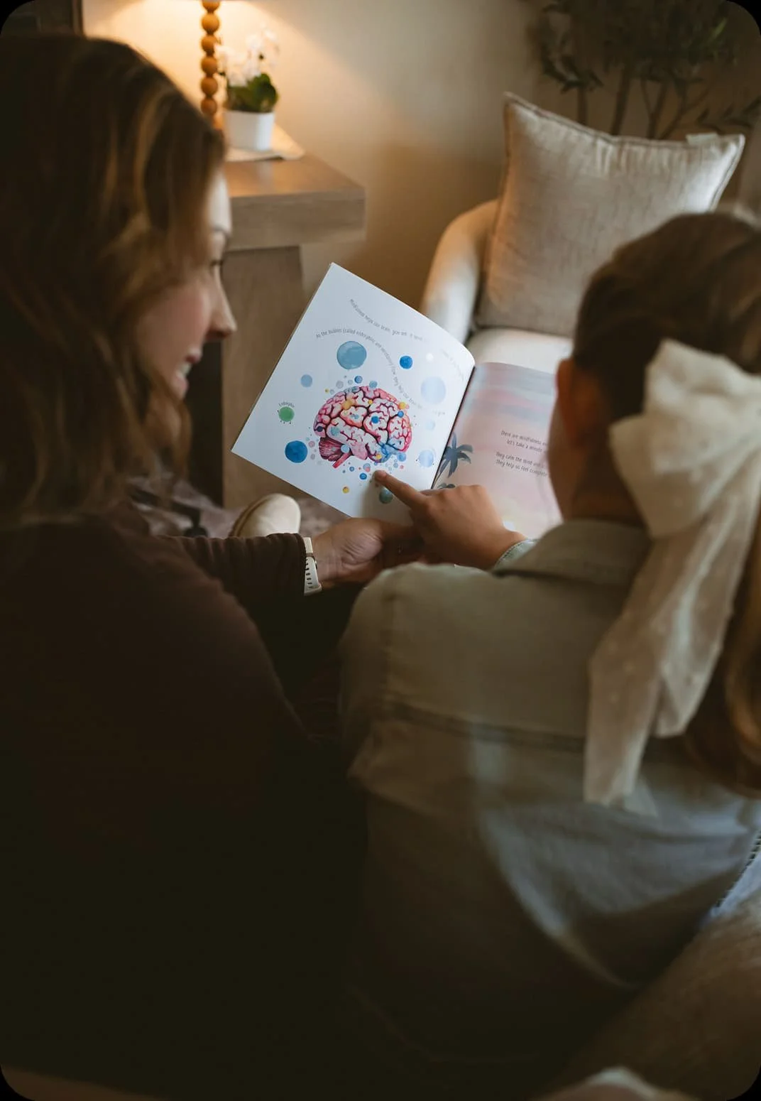 Therapist reading an illustrated book about the brain with a child during a counseling session