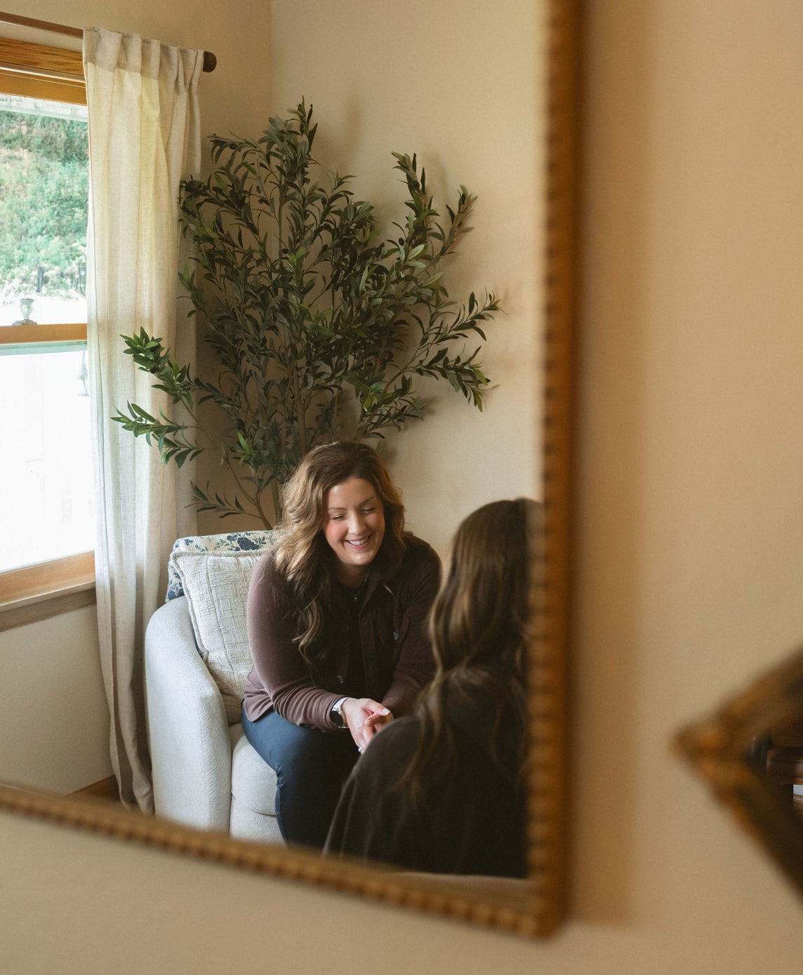 Hannah Harren, LPC, smiling warmly with a client during a counseling session at The Haven