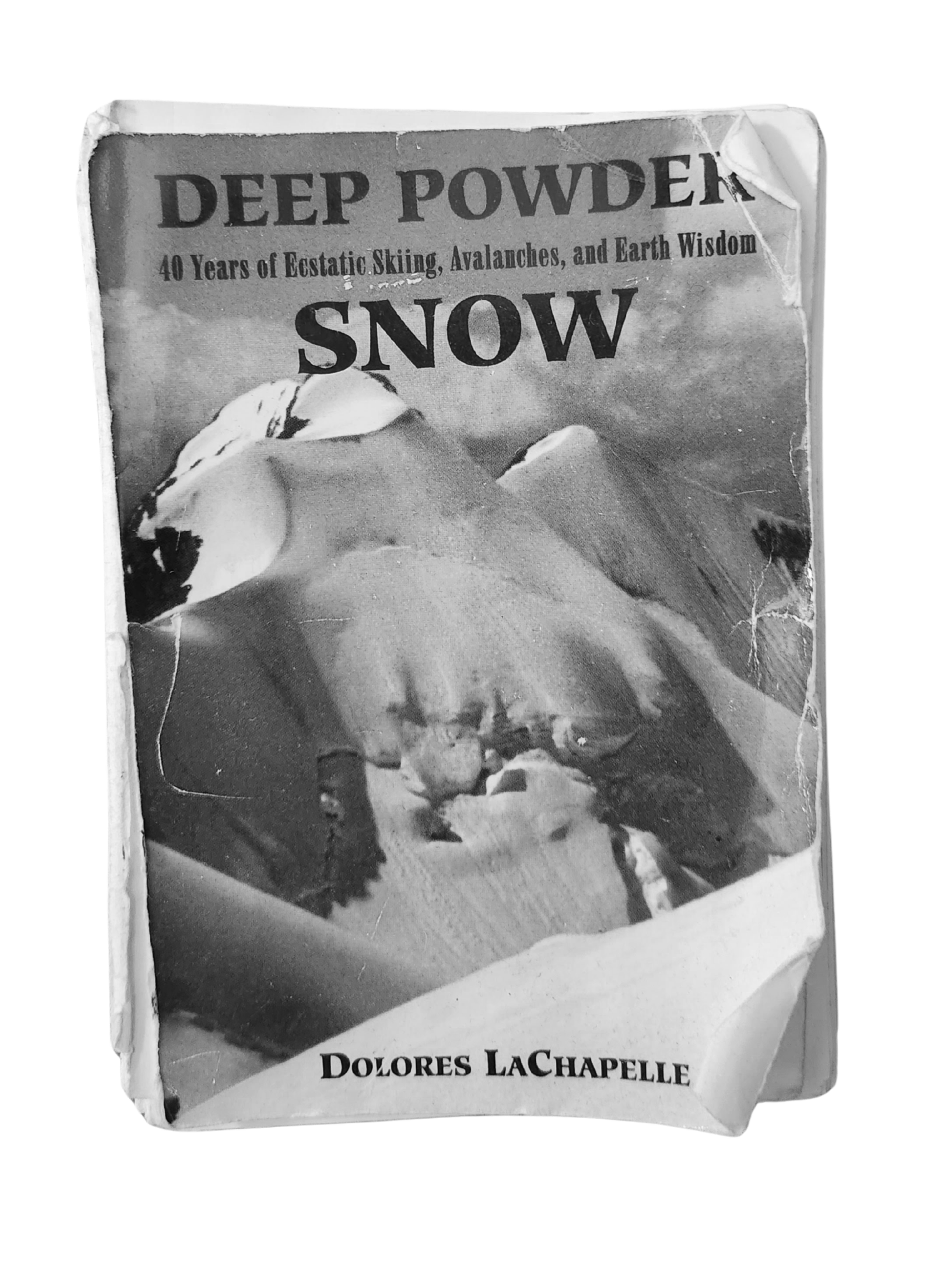 The original cover of 'Deep Powder: 40 Years of Estatic Skiing, Avalanches, and Earth Wisdom' by Dolores LaChapelle, featuring a snowy mountain.
