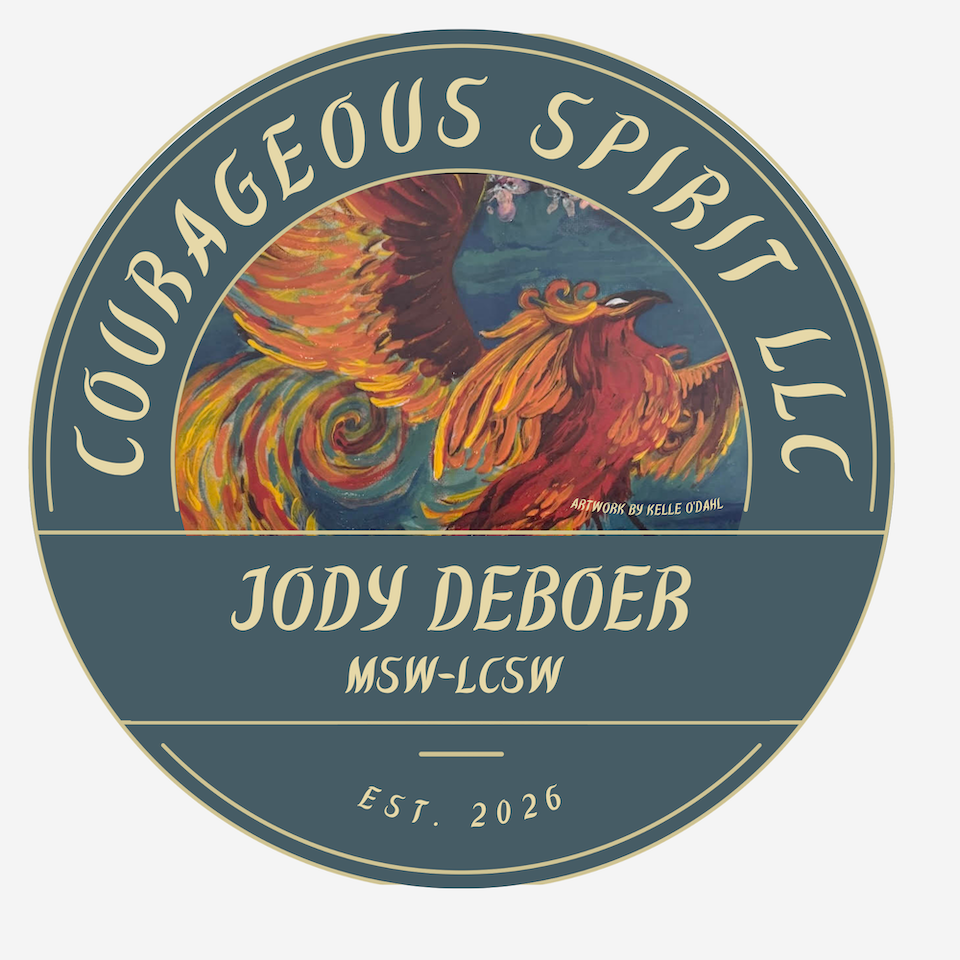 A circular logo with a colorful painted phoenix at the center and the text 'Courageous Spirit LLC' at the top, 'Jody DeBoer MSW-LCSW' in the middle, and 'EST. 2026' at the bottom.