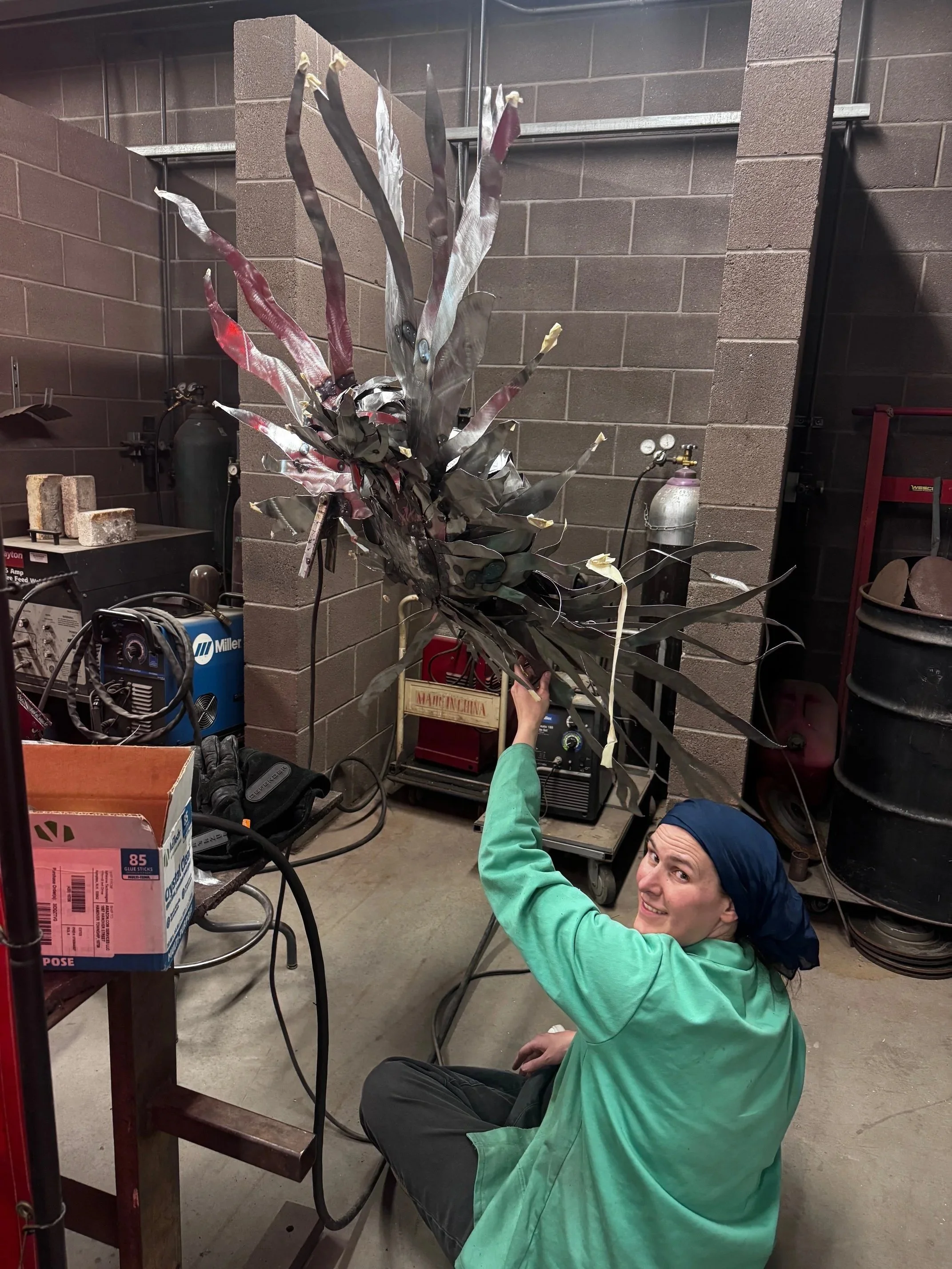 Caught by my shopmate in my "lunch lady bandana." Trust me, having a piece of molten slag hit your scalp is unpleasant! Maybe I should have used a filter or edited this before displaying it for the world?