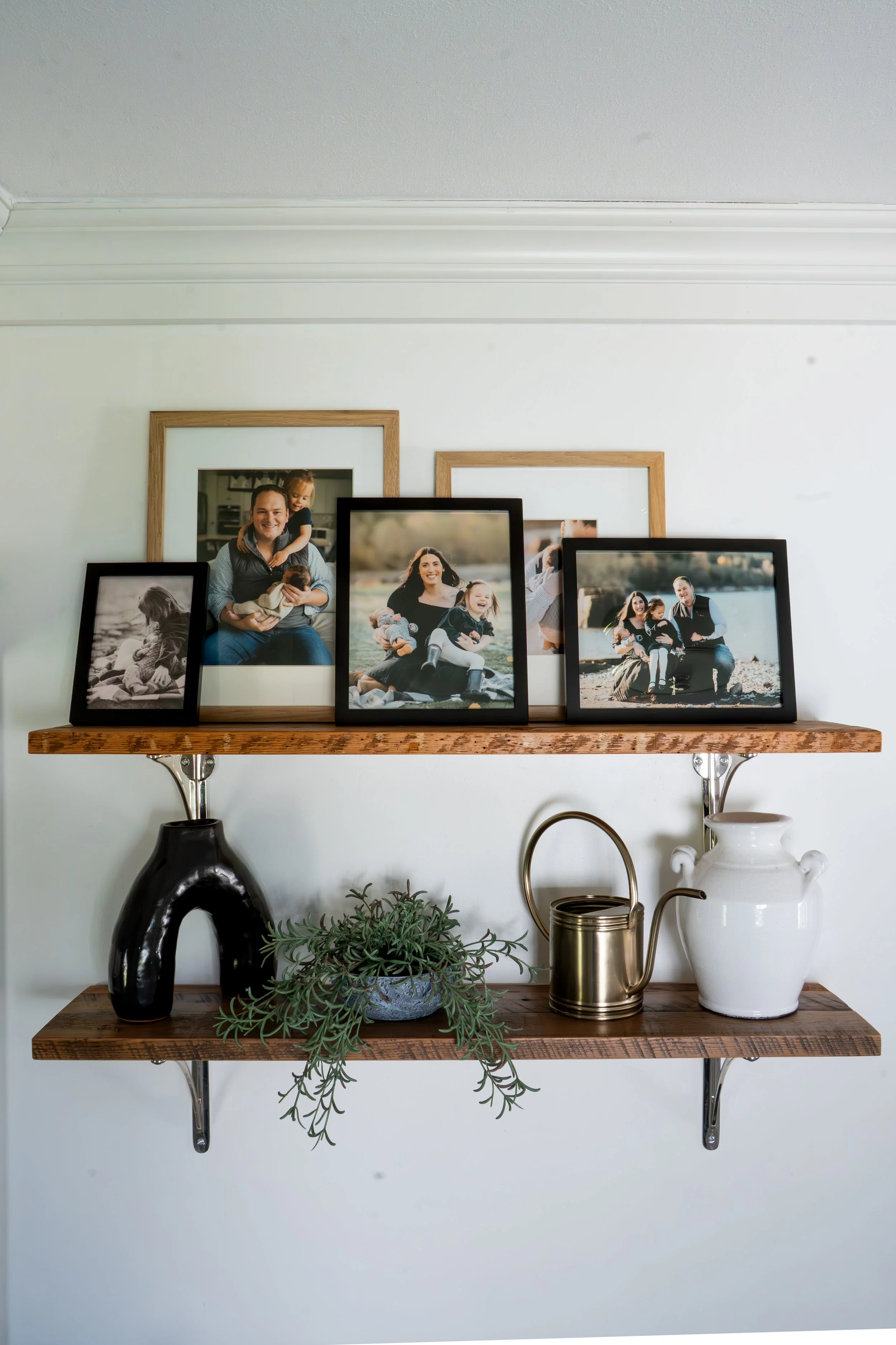 Gallery wall with framedStyled shelf vignette with stacked books, organic decor, and layered greenery — LR Studio home styling artwork and decorative vignette — LR Studio interior styling, West Hartford CT