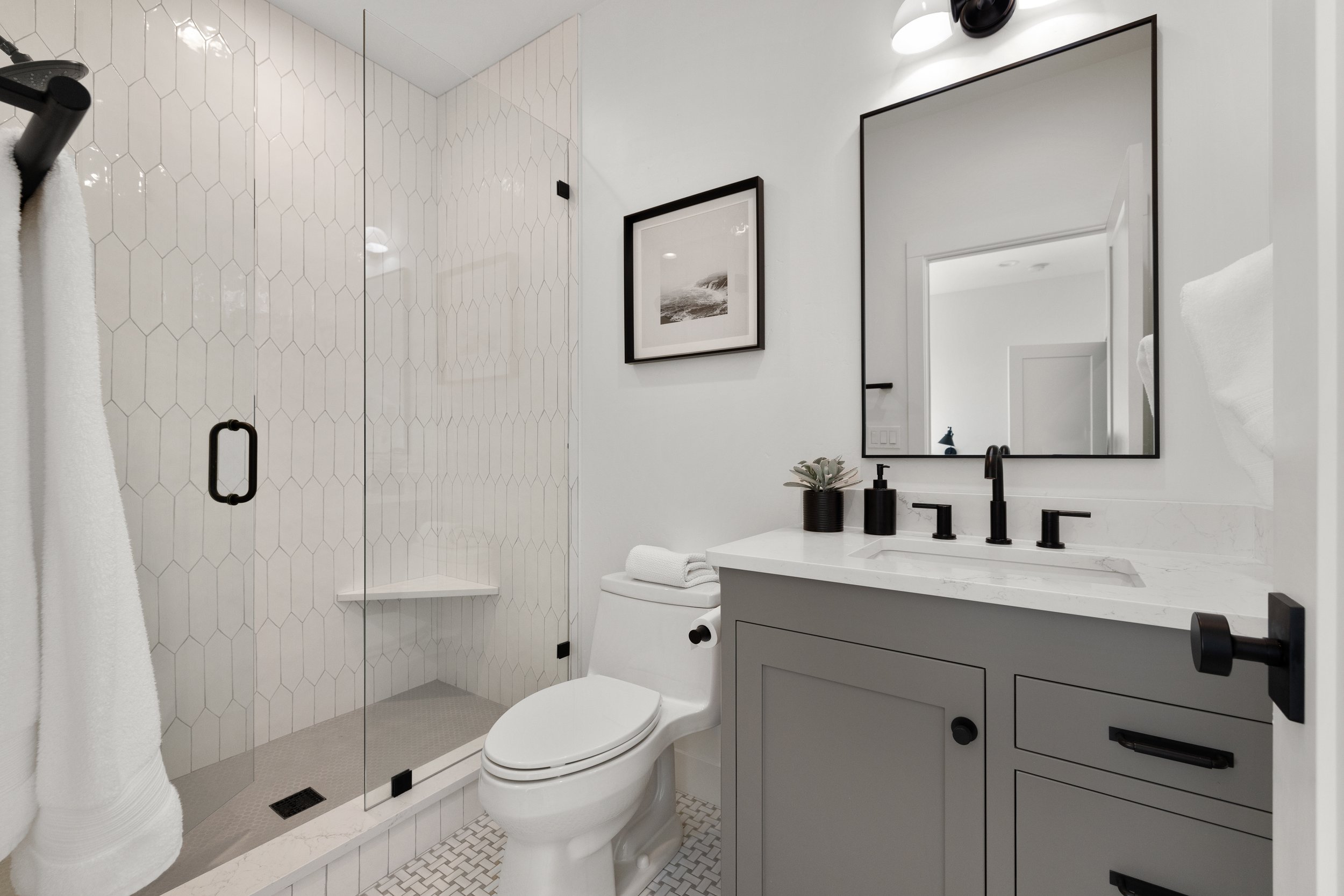 Elegant master bathroom with freestanding soaking tub and shiplap wall — LR Studio home styling, Connecticut