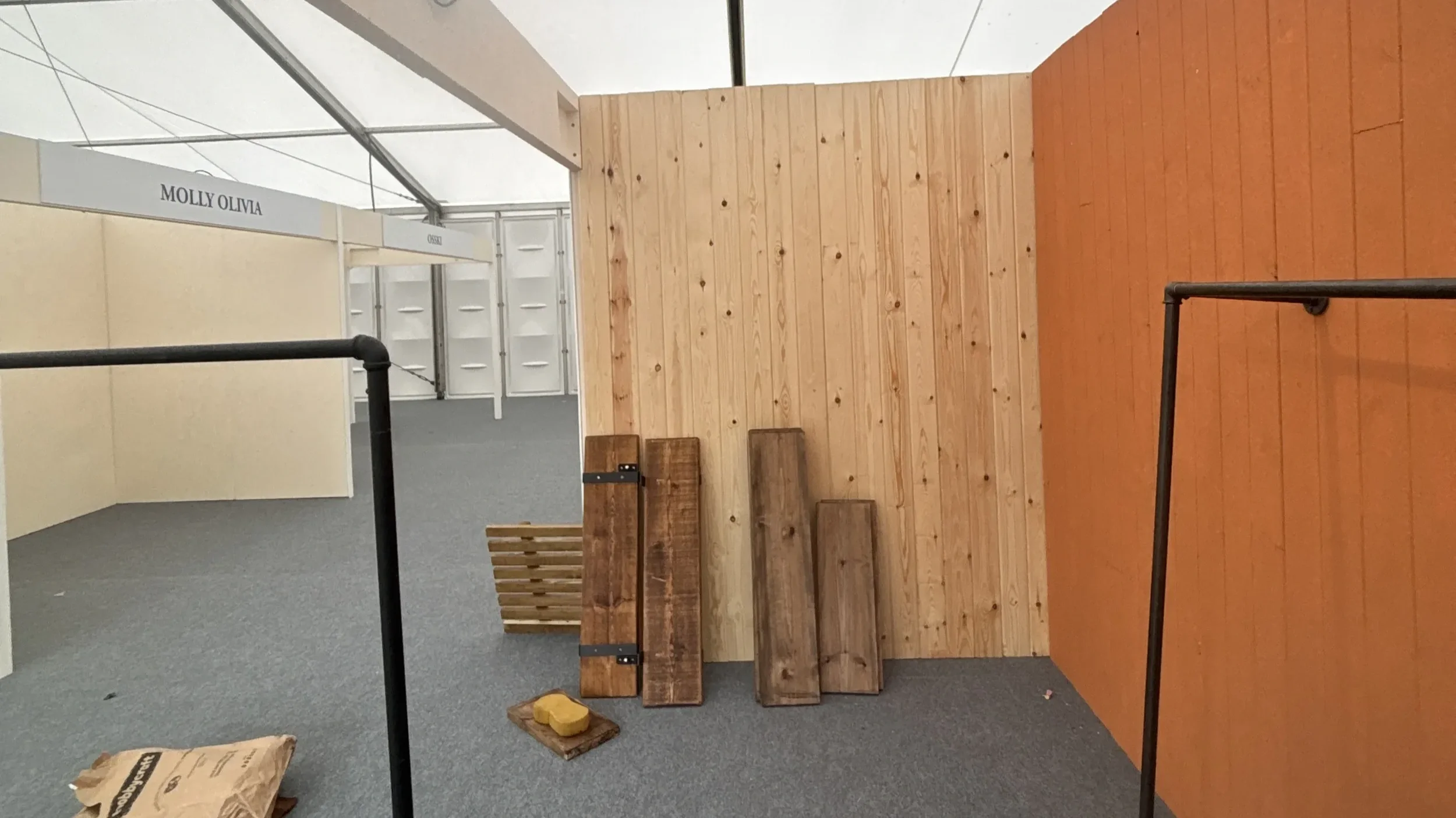 Patcha London bespoke event stand build in progress inside marquee with terracotta panels and timber materials on floor