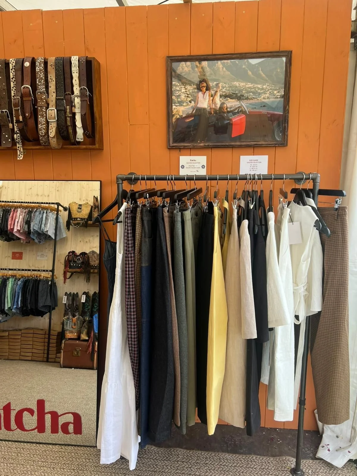 db-studios-patcha-london-clothing-rails-against-orange-wall.jpg
