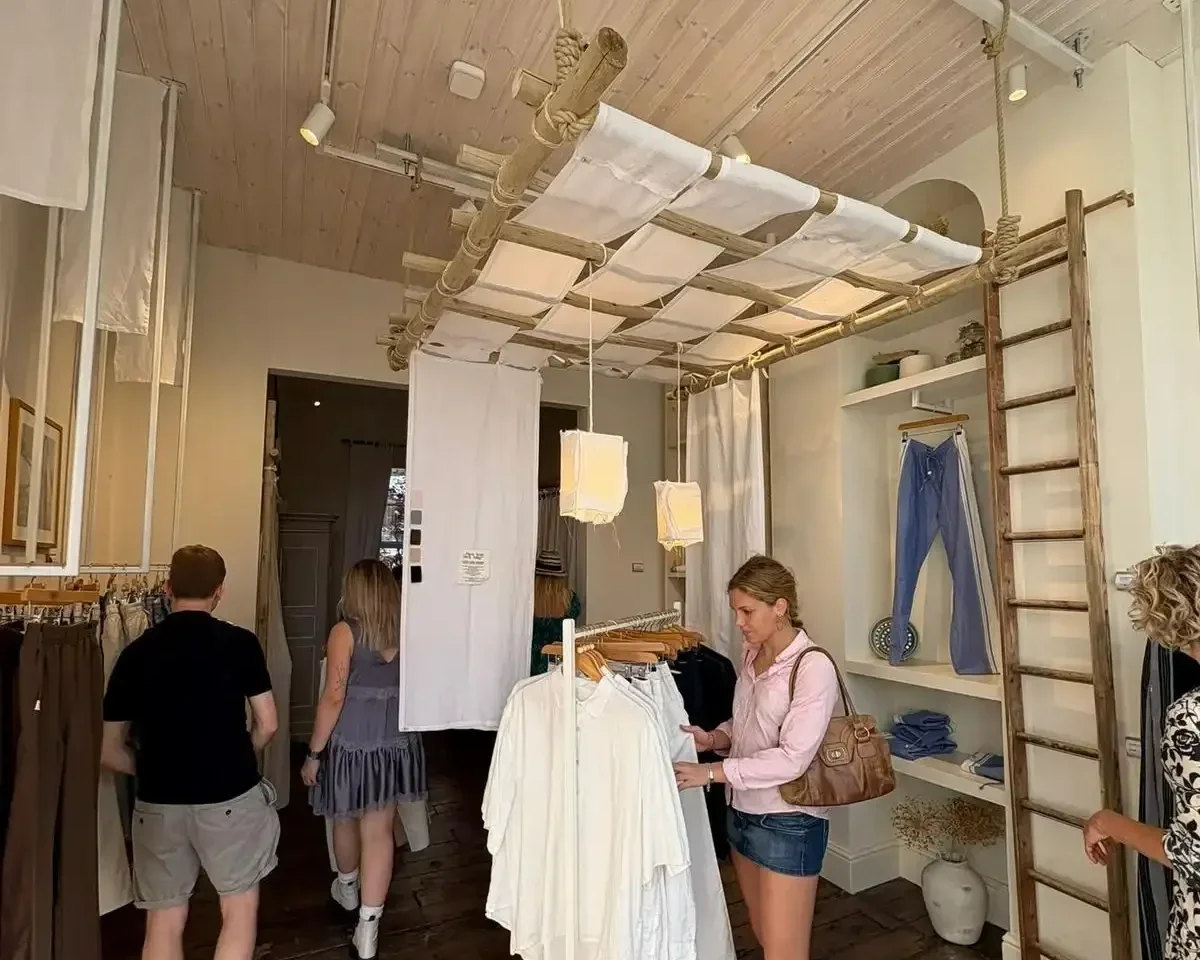 Customers browsing Tom's Trunks bespoke retail interior with bamboo lattice ceiling installation and clothing on racks