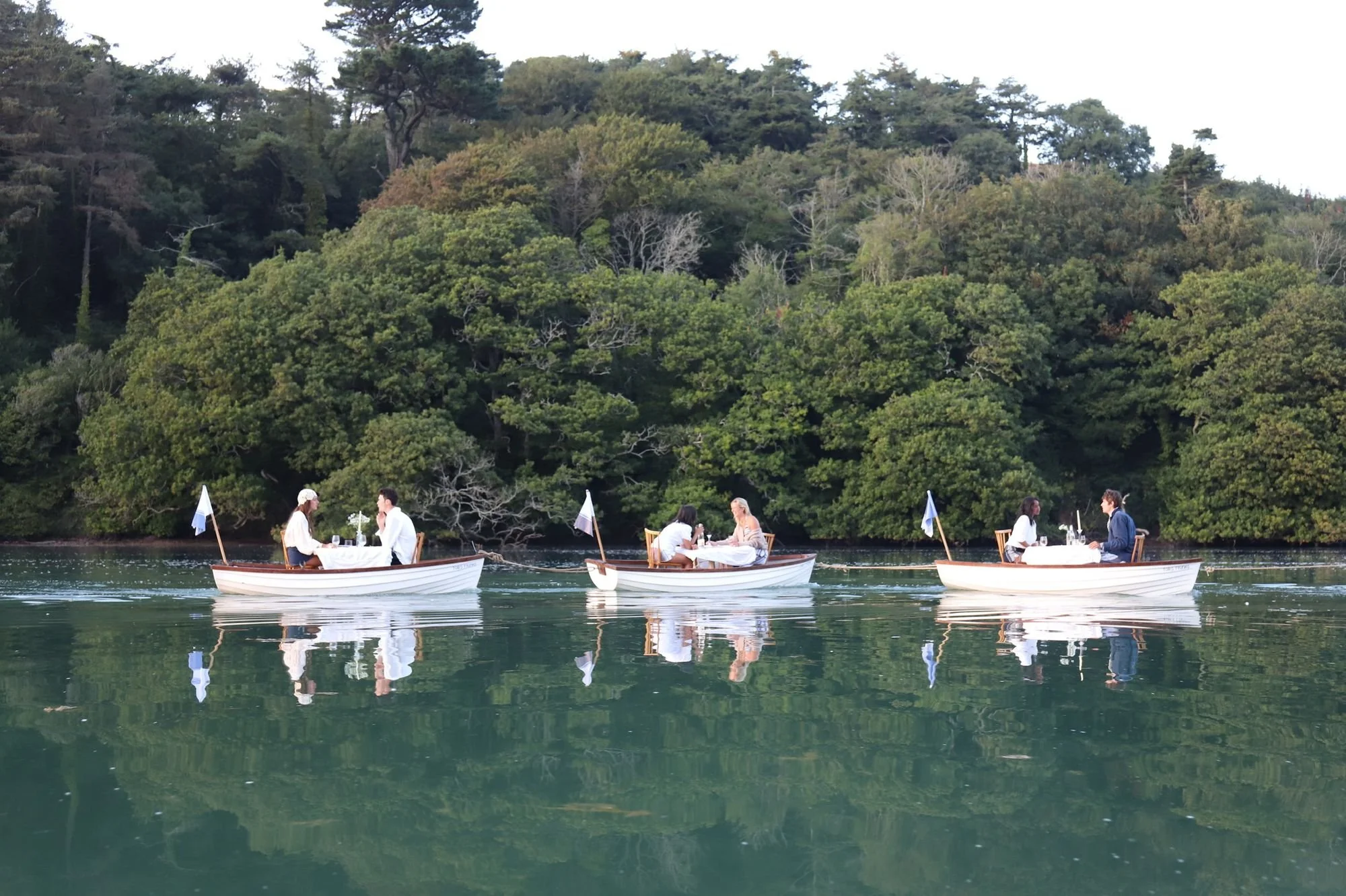 db-studios-toms-trunks-three-dining-boats-on-the-water.jpg