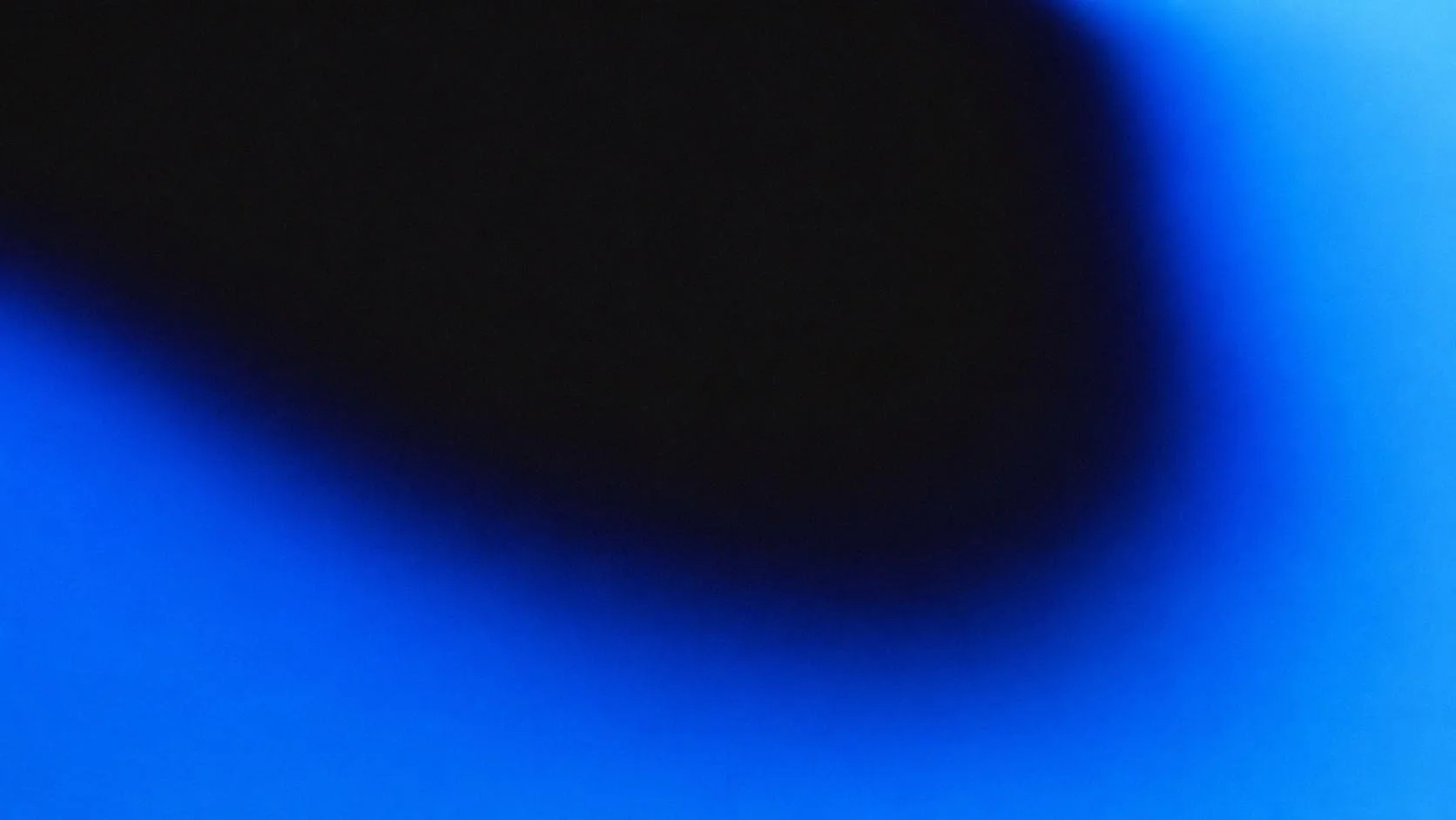 Blurred blue and black gradient background with no distinguishable objects.