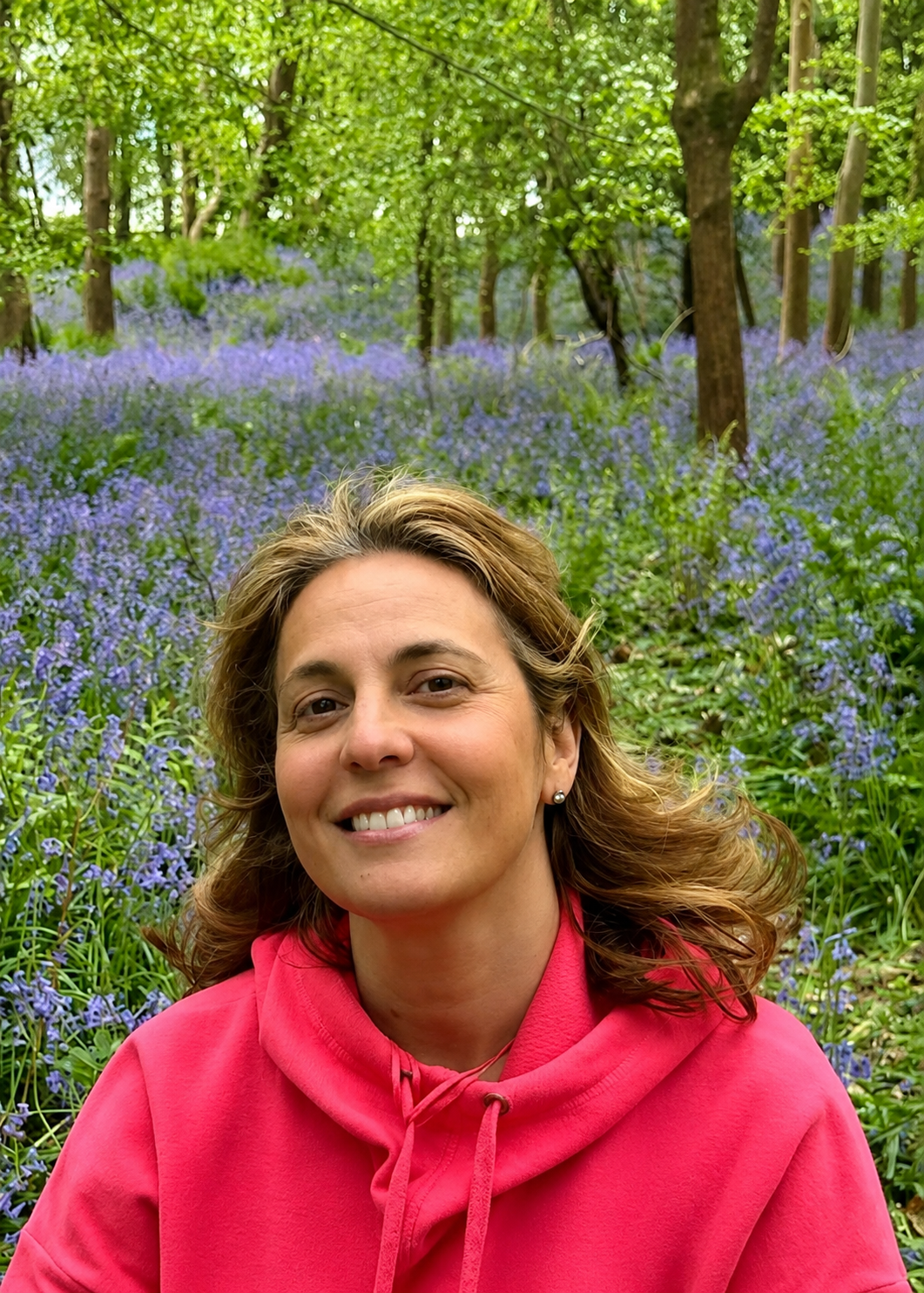 Lourdes Marinetto sitting in a bluebell woodland