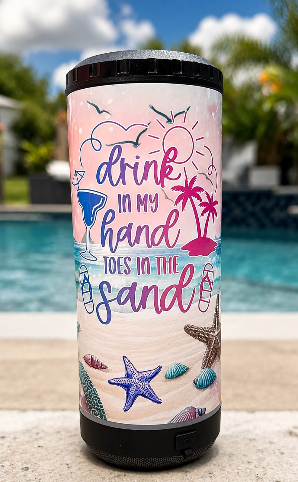 A smart speaker with a beach-themed design and humorous text, set outdoors near a pool under a partly cloudy sky.