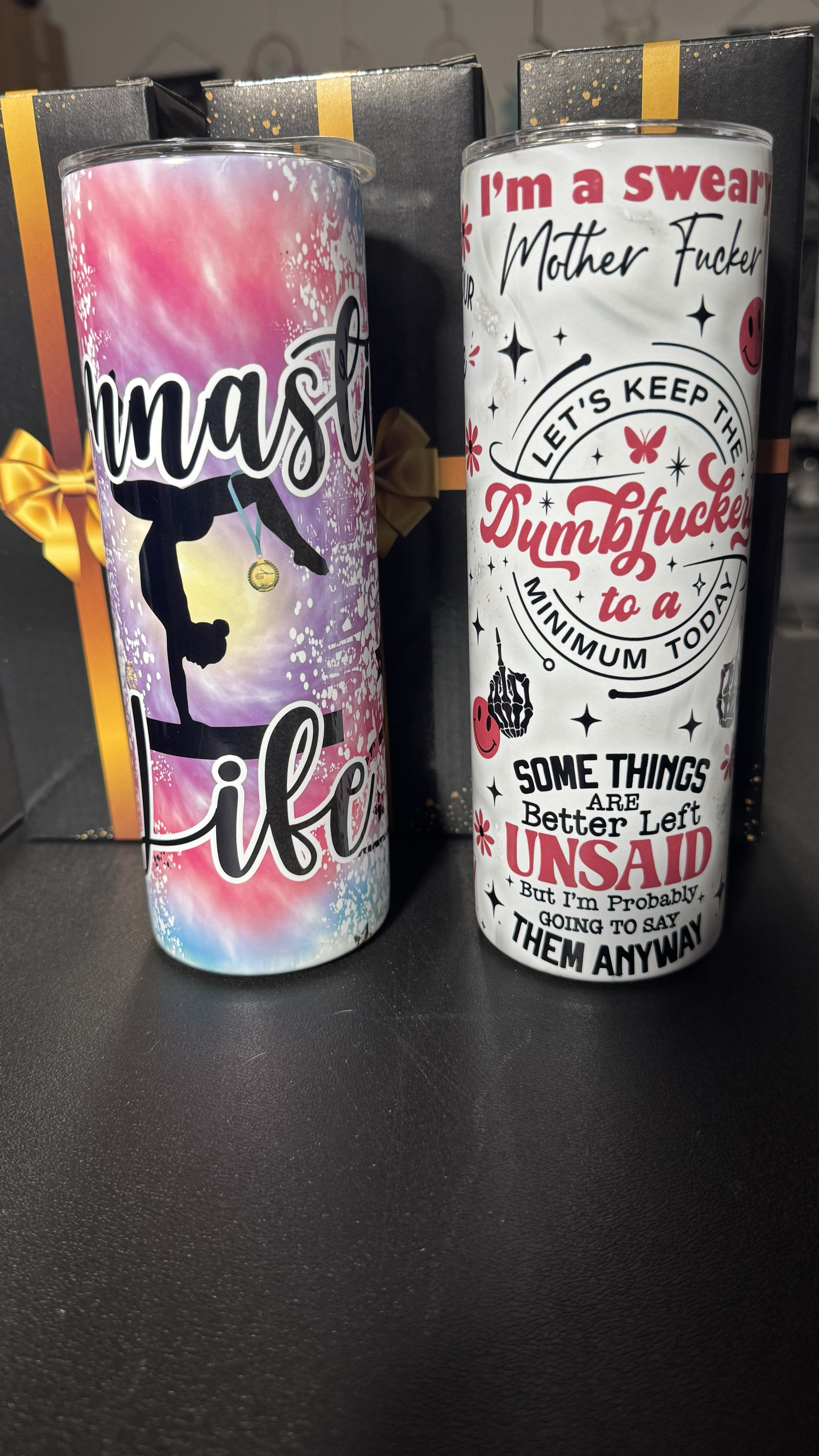 Two inscribed candles with humorous messages on a black background.