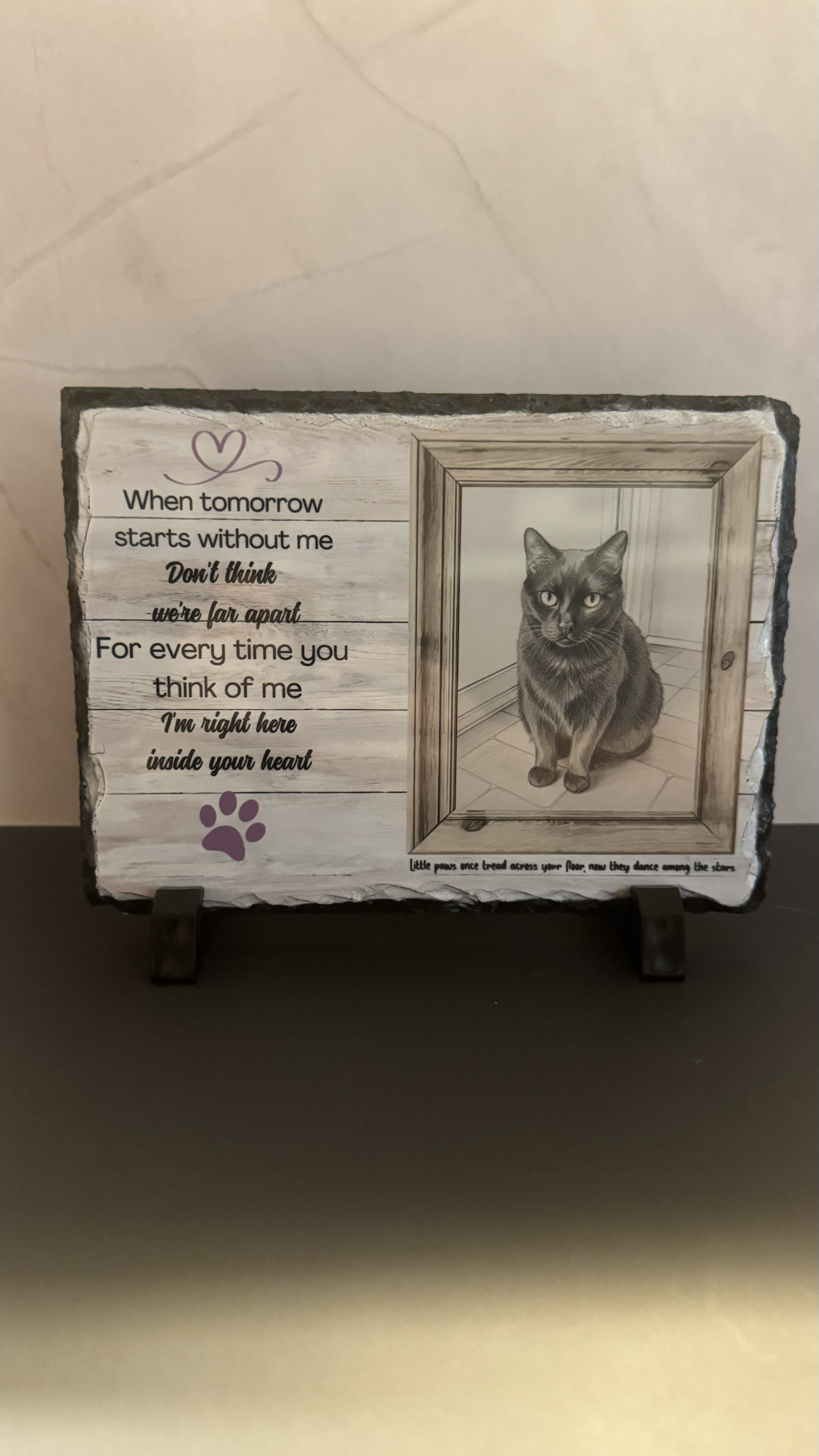 A sign with poetry and a picture of a cat. The poem reads: "When tomorrow starts without me, don't think we're far apart. For every time you think of me, I'm right here inside your heart." The picture of the cat appears to be a black and gray tabby s