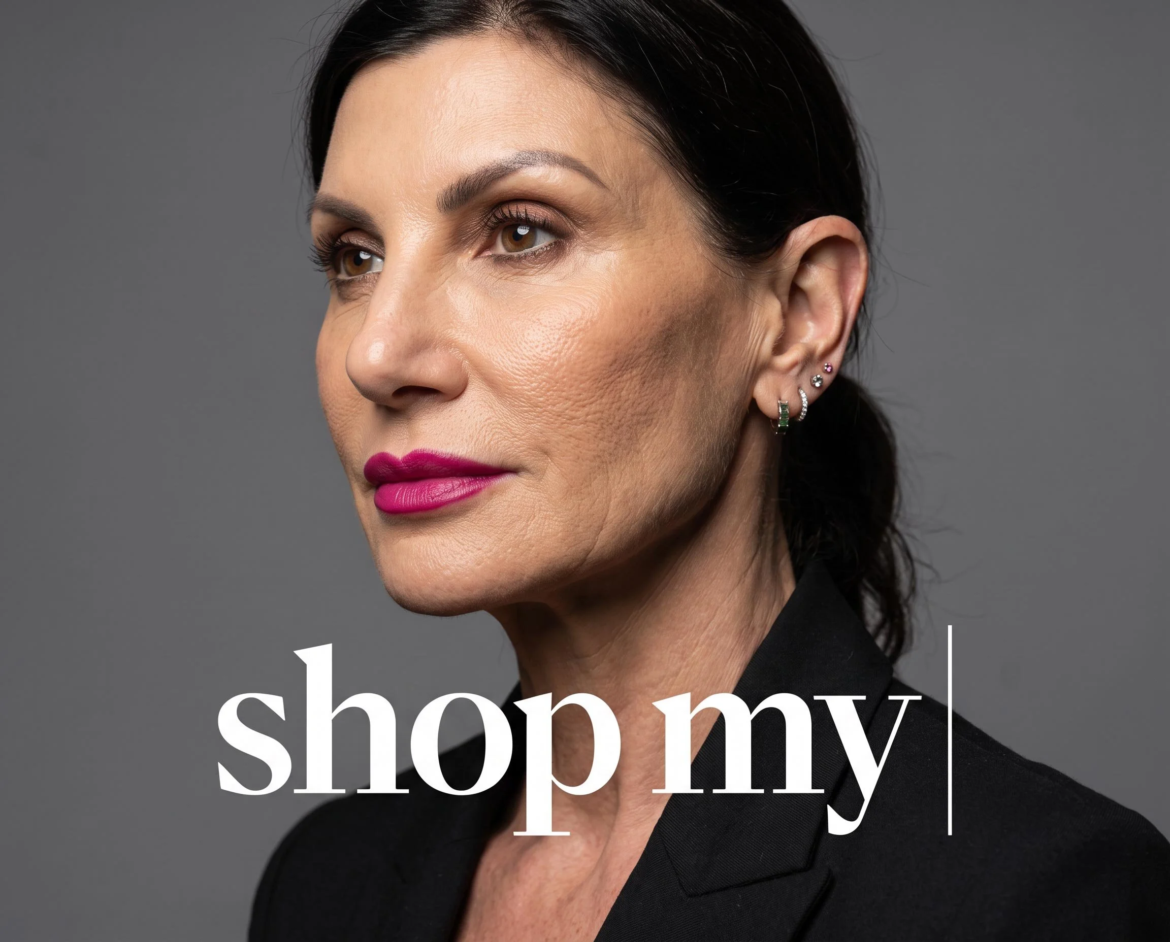 Close-up of a woman with dark hair, brown eyes, and pink lipstick, wearing multiple earrings, against a gray background, with white text overlay that says "shop my".