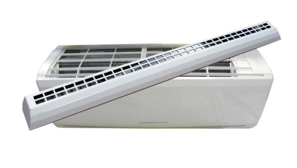 A split-type air conditioner mounted on a wall, with an indoor unit and a long vent cover placed above it.