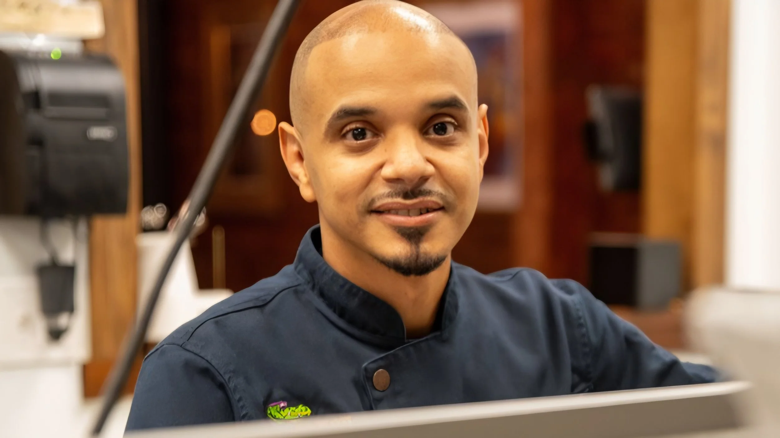 Chef Ivan Felix of The Mamou in Springfield MA. Male chef headshot with kitchen background
