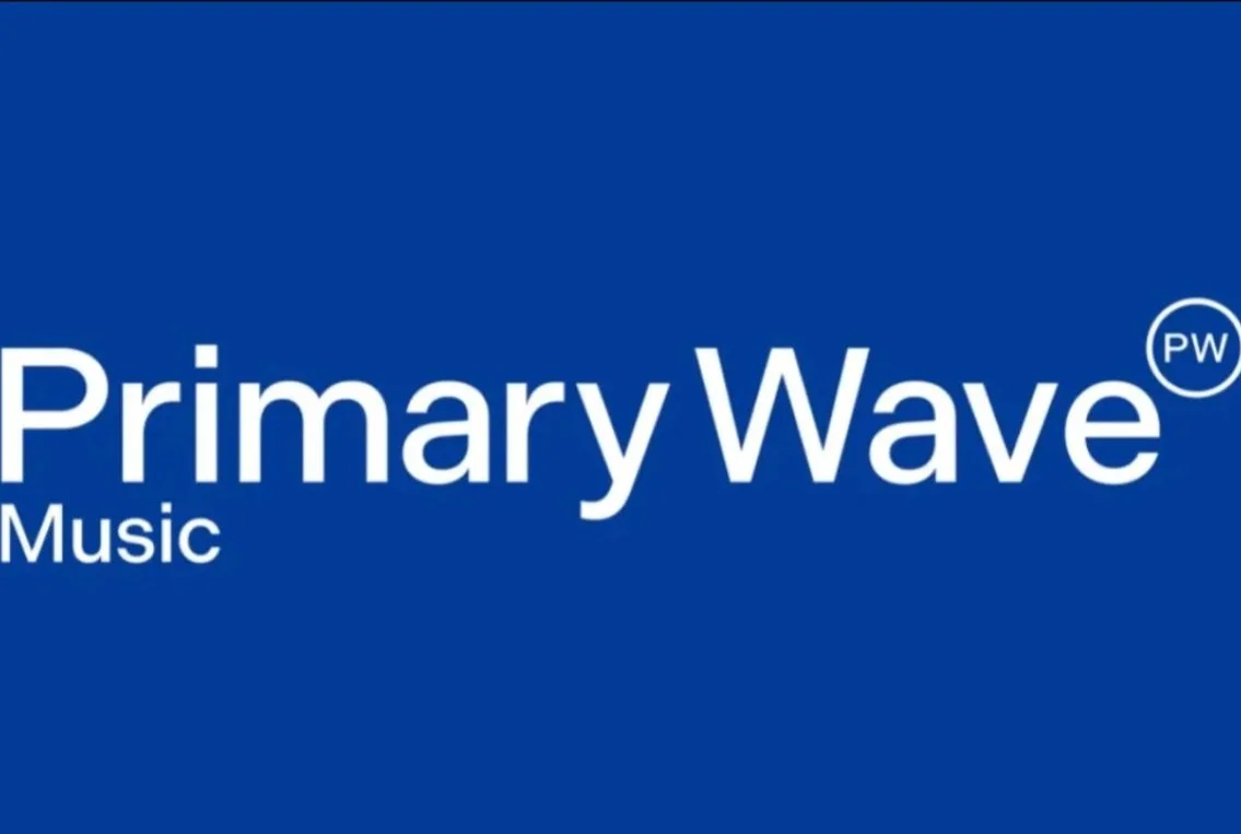 Blue background with white text reading "Primary Wave Music" and a small circled logo with the letters "PW".
