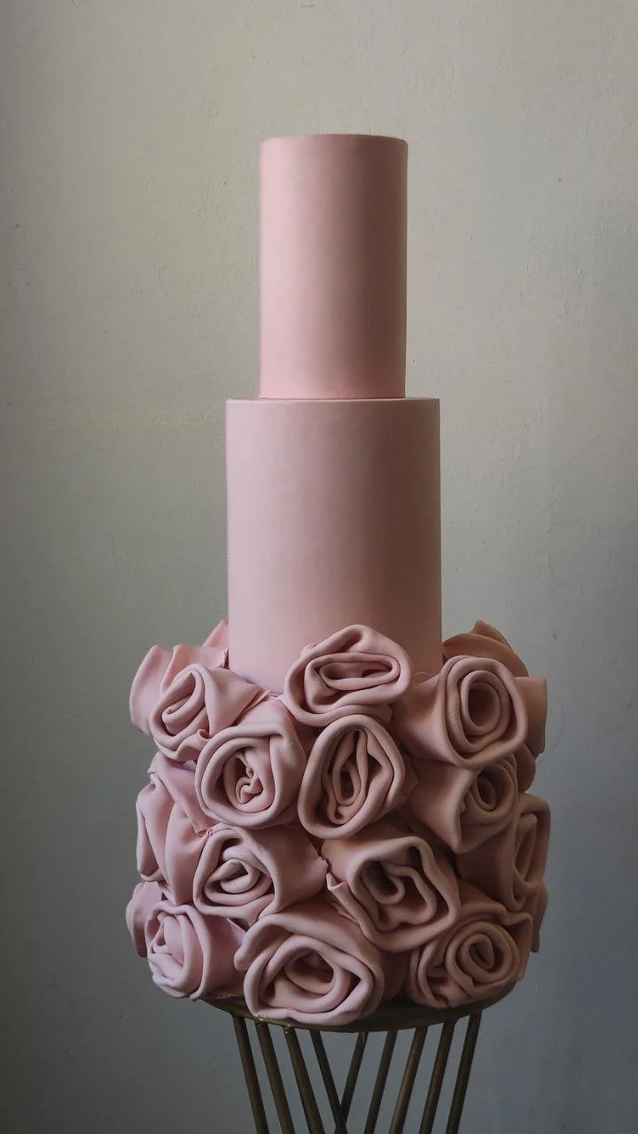 Modern pink celebration cake with elegant fondant draping