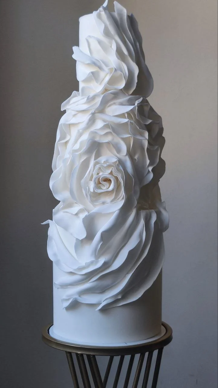 Modern luxury white wedding cake with contemporary ruffle design