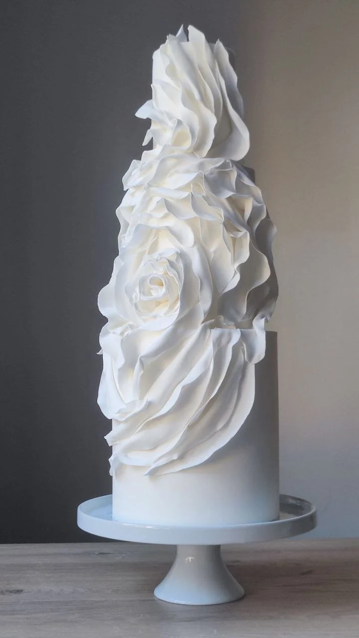 Modern luxury white wedding cake with contemporary draped design