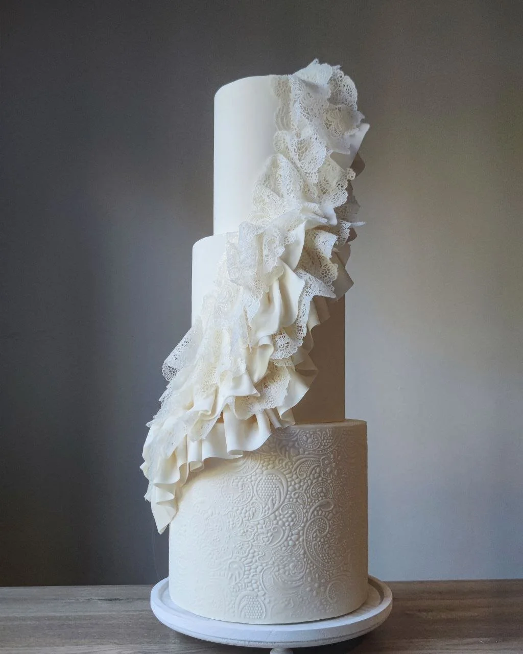 modern luxury ivory wedding cake with lace 