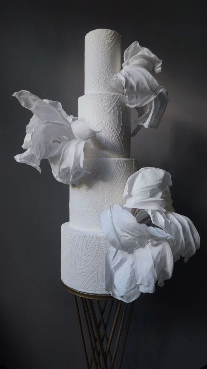 Modern luxury white wedding cake with contemporary textured design