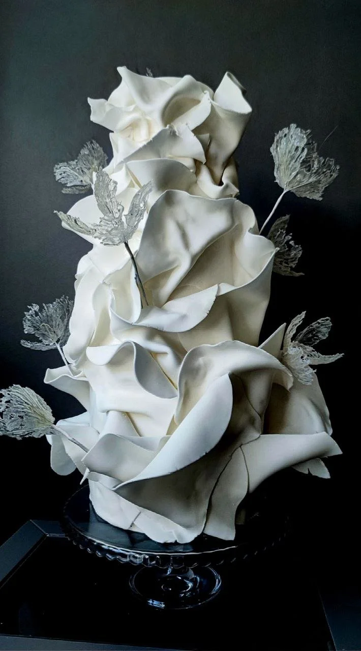 White sculptural wedding cake decorated with biautiful crystal flowers, a contemporary luxury wedding cake design
